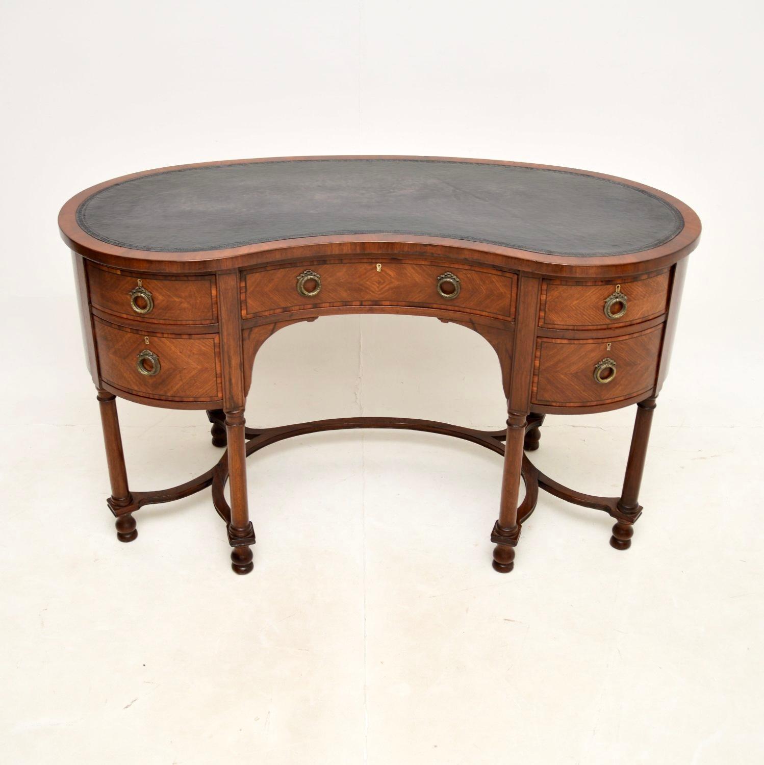 A beautiful antique kidney shaped desk. This was made in England, it dates from around the 1890-1910 period.

This actually has a brass plaque in the top drawer from when it was presented as a gift in 1947. The wood has walnut cross banding on the