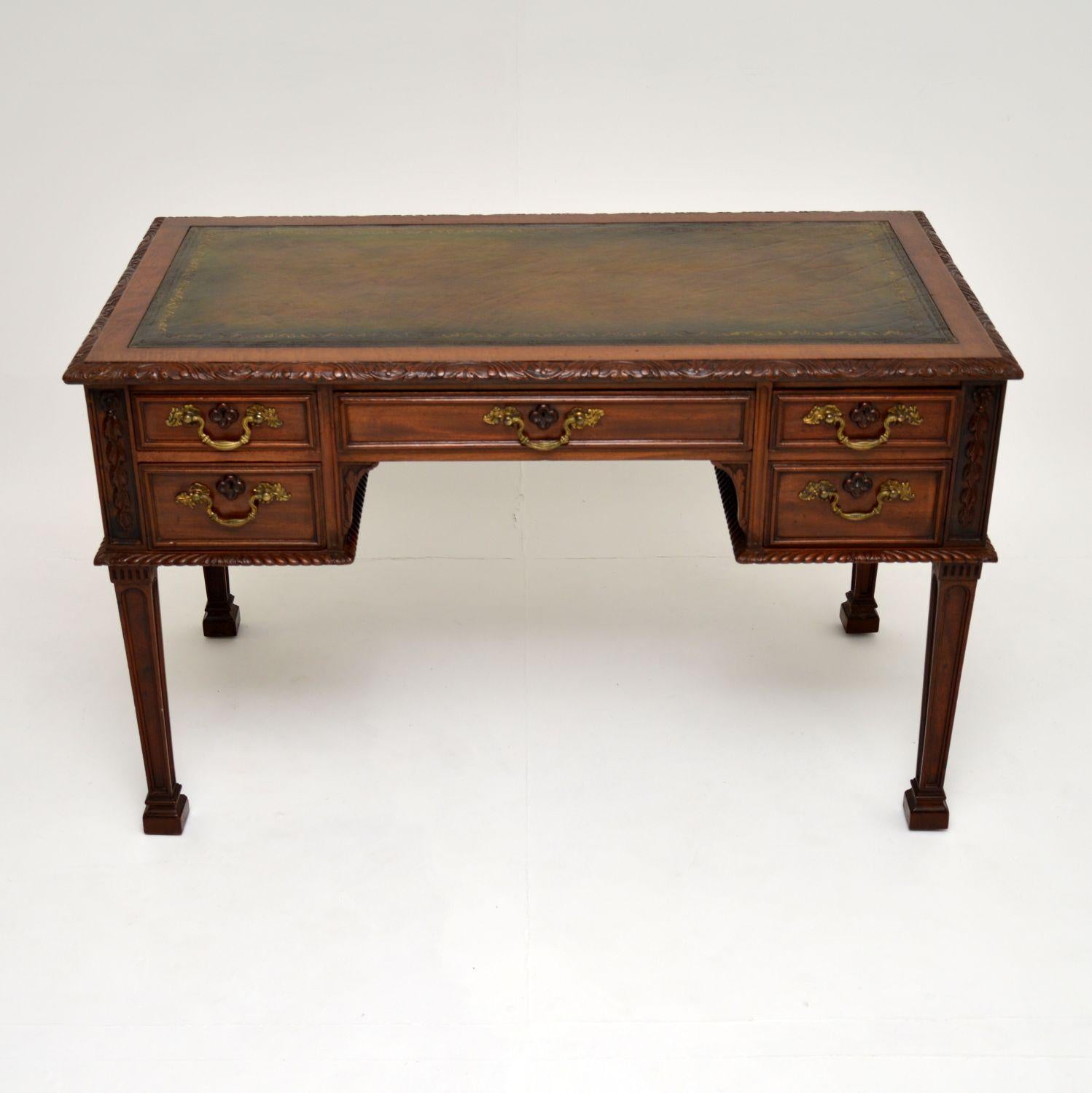An excellent antique mahogany desk, in the Chippendale style. This was made in England & dates from around the 1890-1900 period.

The quality is absolutely magnificent, this has stunning carved details throughout on all sides. Even the escutcheons