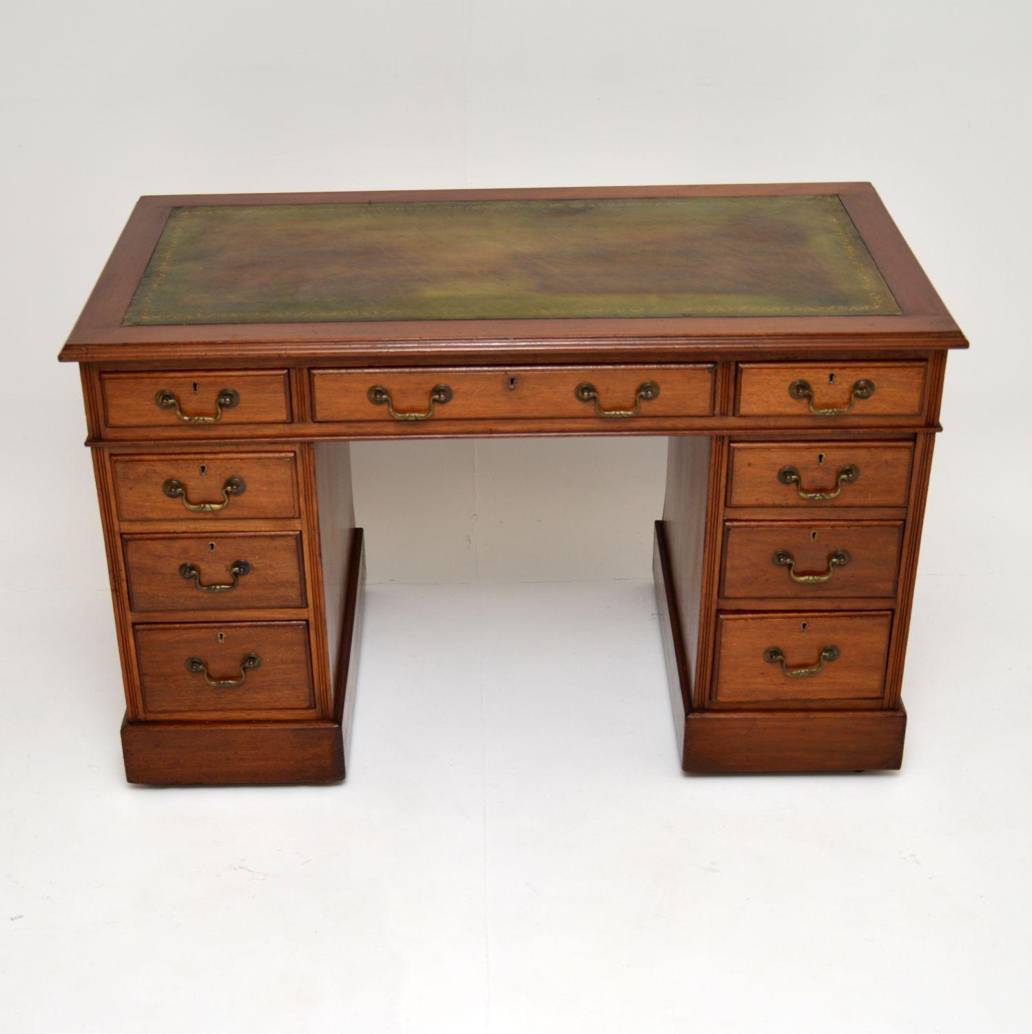 A fantastic original antique Victorian period desk in mahogany, dating from the 1880-1900 period.

This is very well made and of excellent quality. It’s a useful size, and has quite small proportions for a pedestal desk. The pedestals sit on