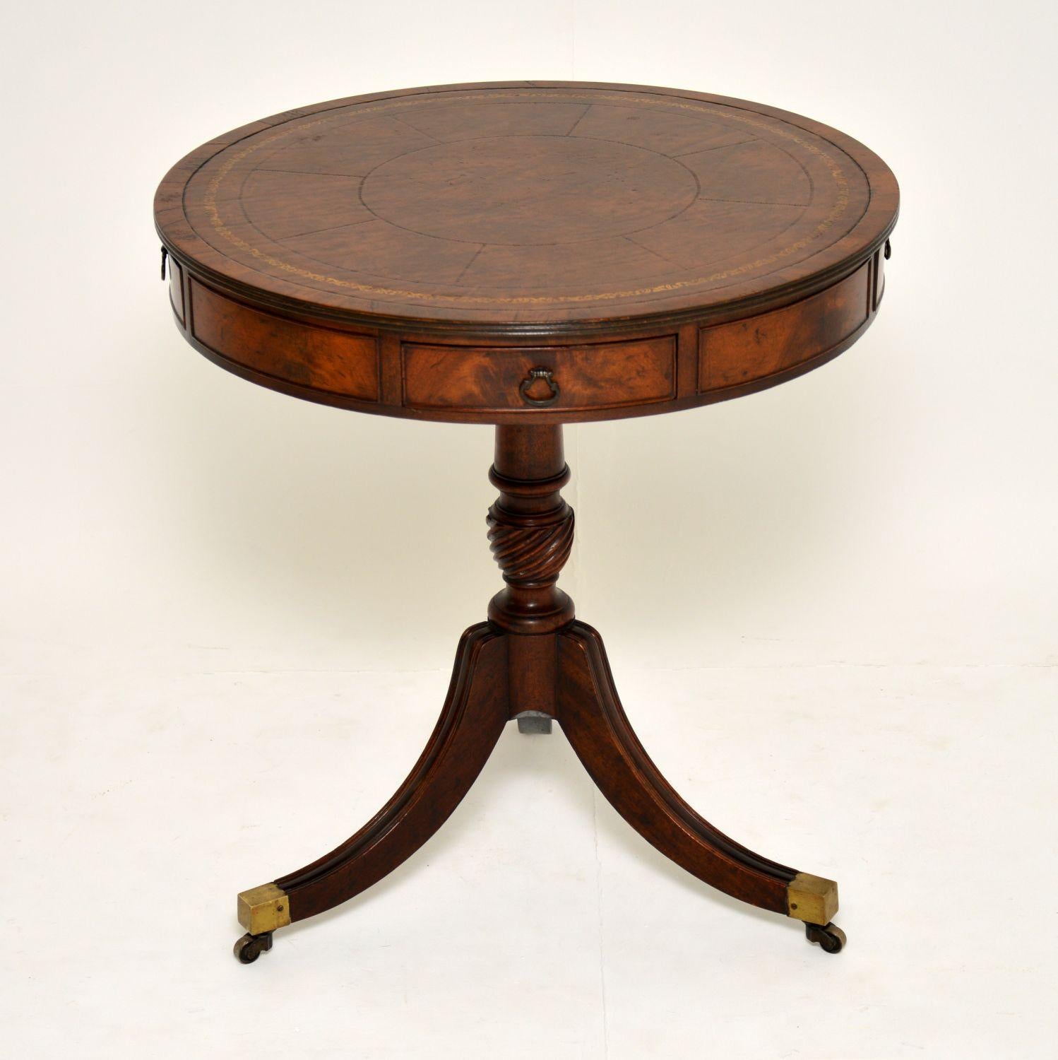 This antique mahogany revolving drum table has some very nice designs and is of fine quality.

It has a segmented and tooled inset leather top surface, with mahogany cross banding and a reeded top edge. There are four drawers with original brass