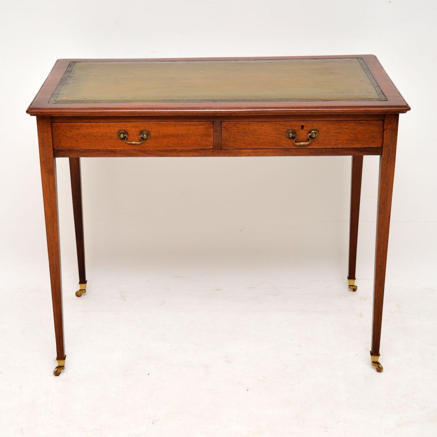 Very elegant smallish leather top writing table in mahogany and with a polished back. It’s late Victorian from circa 1890-1900 period and is in excellent condition. The writing surface is hand tooled and a faded green color, with plenty of
