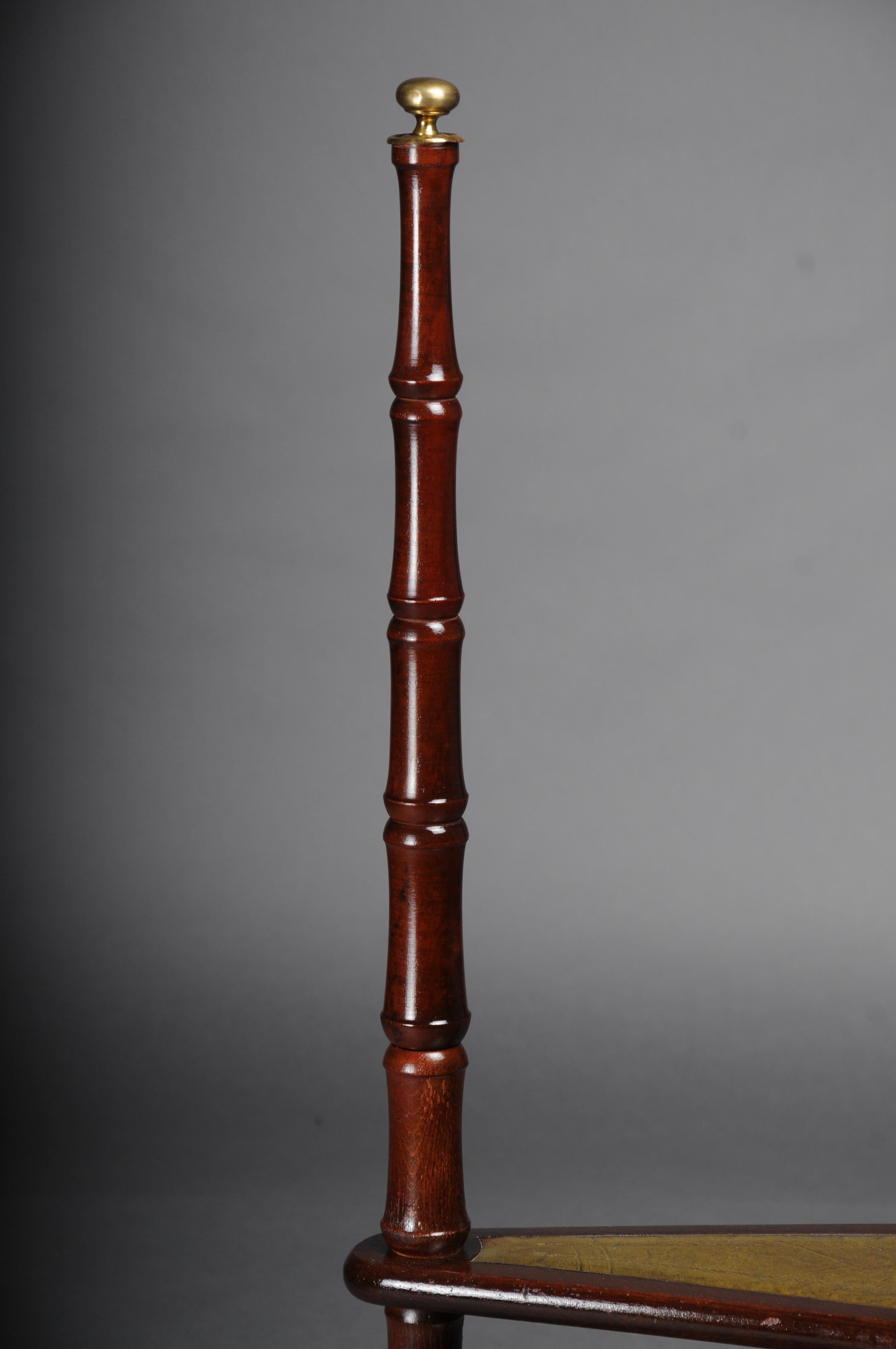 Antique mahogany library ladder, England, 20th century with green leather

Solid wood stained with mahogany. Four steps covered with leather and gold embossing. England, 20th century.

A designer classic.