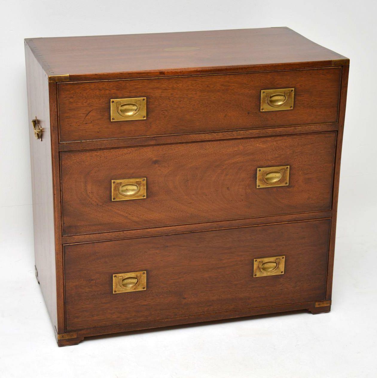 This mahogany campaign style chest of drawers is a great looking piece of furniture and good quality too. It has a brass inset oval plaque on the top, brass corner edges, inset brass military handles & brass side handles. The drawers are deep and