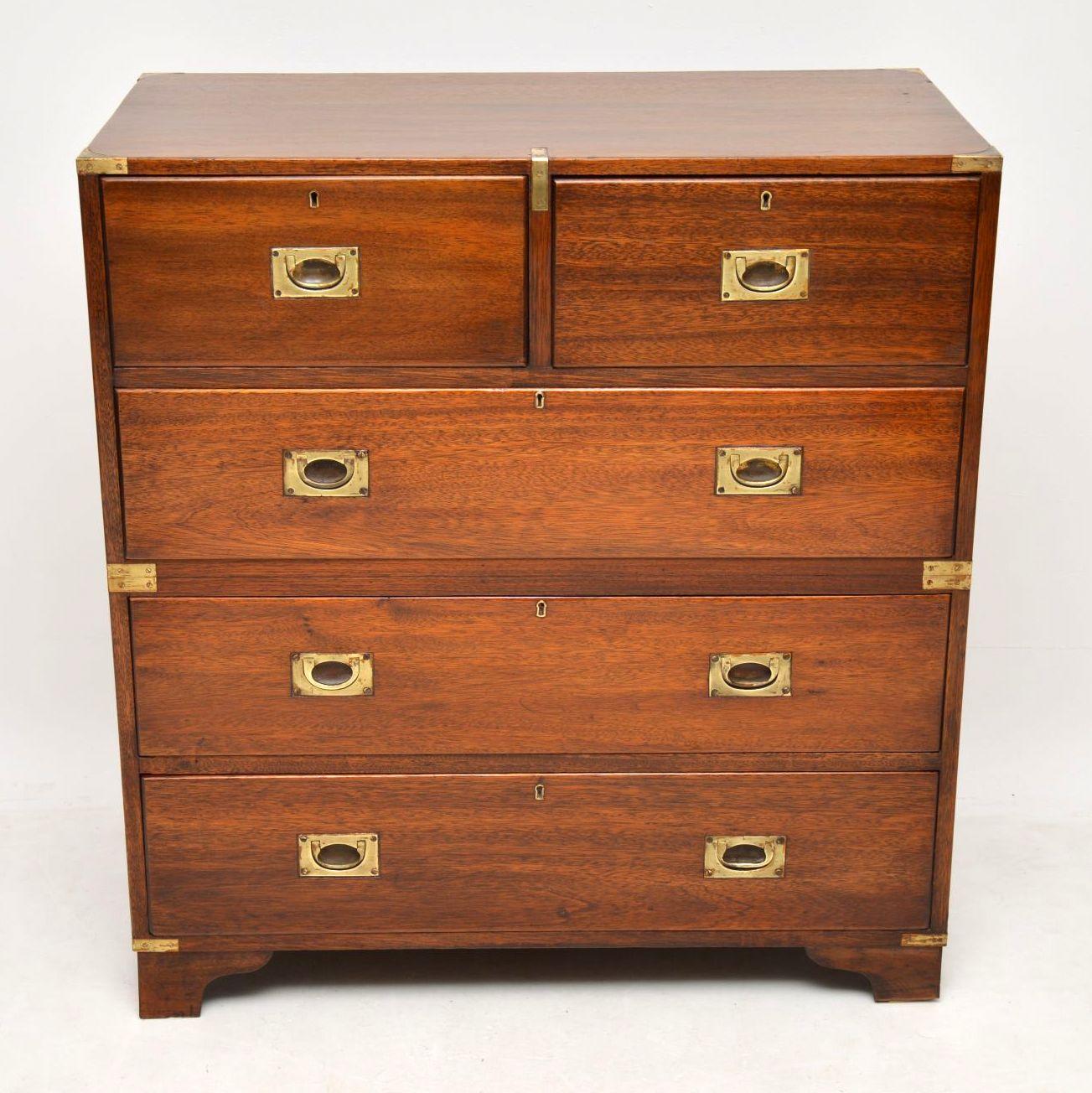 Antique mahogany campaign chest of drawers dating to circa 1930s period and in good condition. This chest gives the appearance of being in two sections, but it is indeed in one piece. It has the classic brass corner fittings and sits on bracket