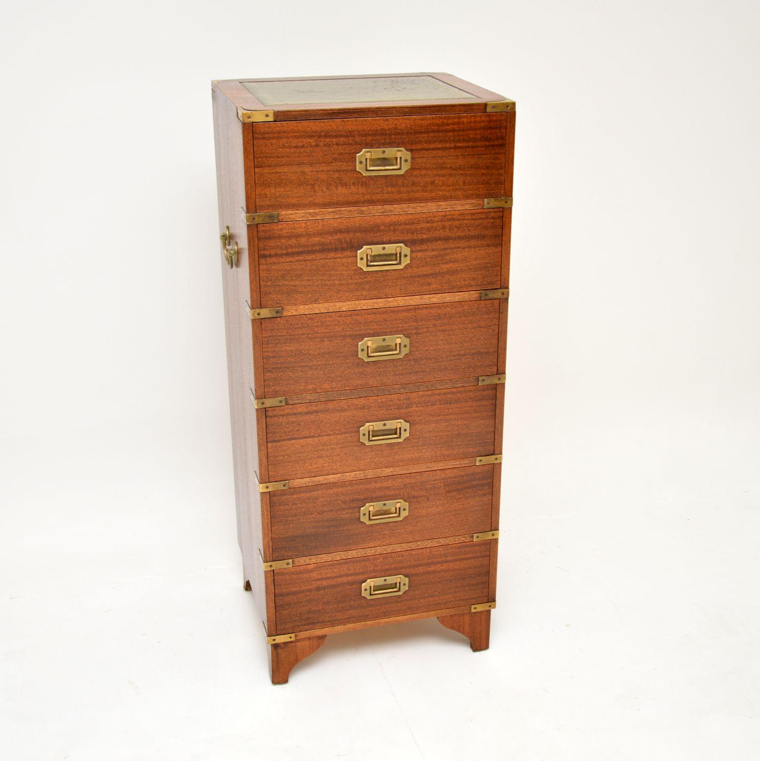 A smart and very well made antique chest of drawers in the military campaign style. This was made in England, it dates from around the 1930’s.

It is of lovely quality and is a very useful size, quite small and low, perfect for a bedside chest or