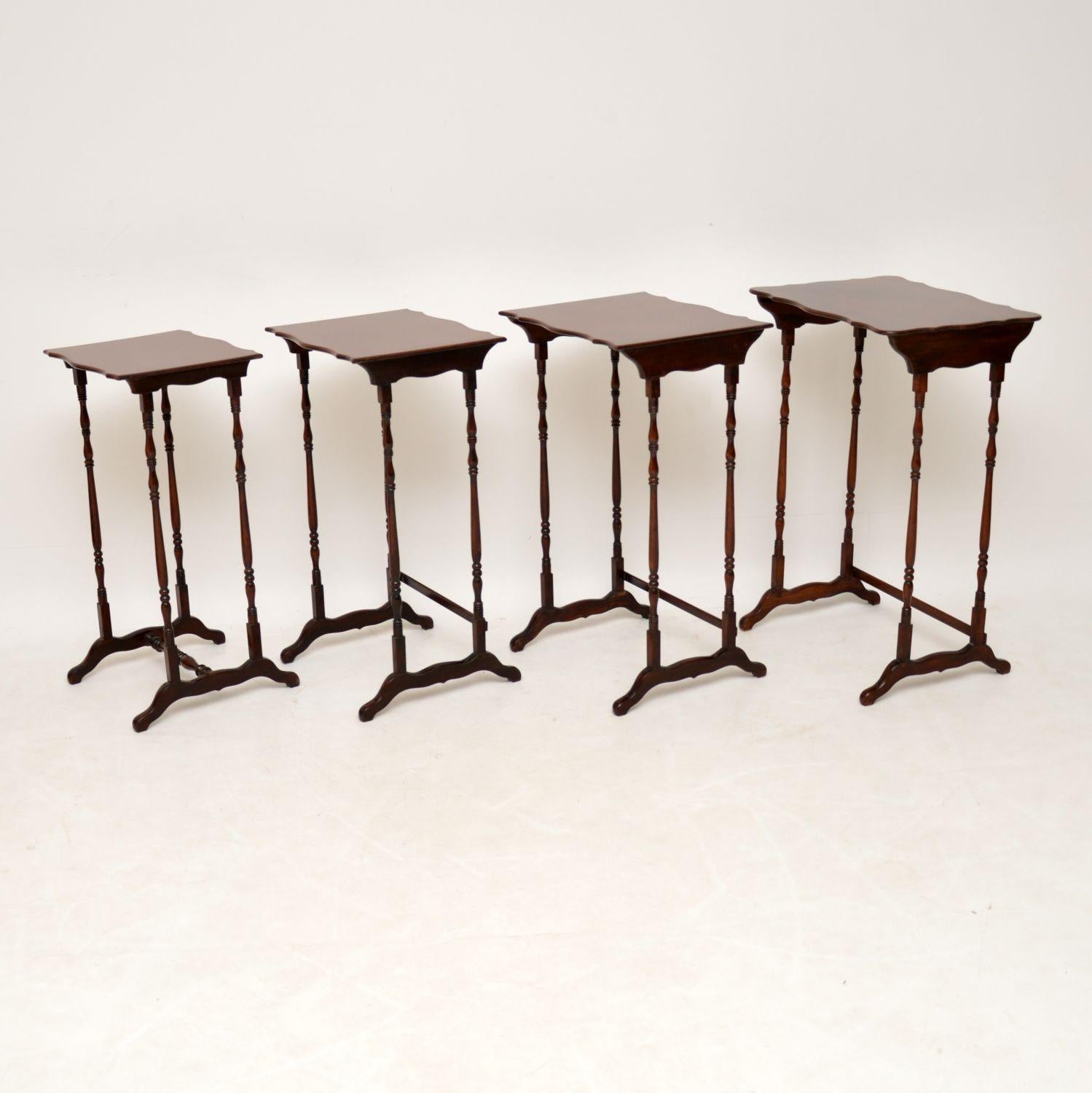 Antique solid mahogany nest of four tables in excellent condition, dating from the 19th century. The tops are shaped all the way around and the tall legs are beautifully turned. There are cross stretchers at the base which help keep them more