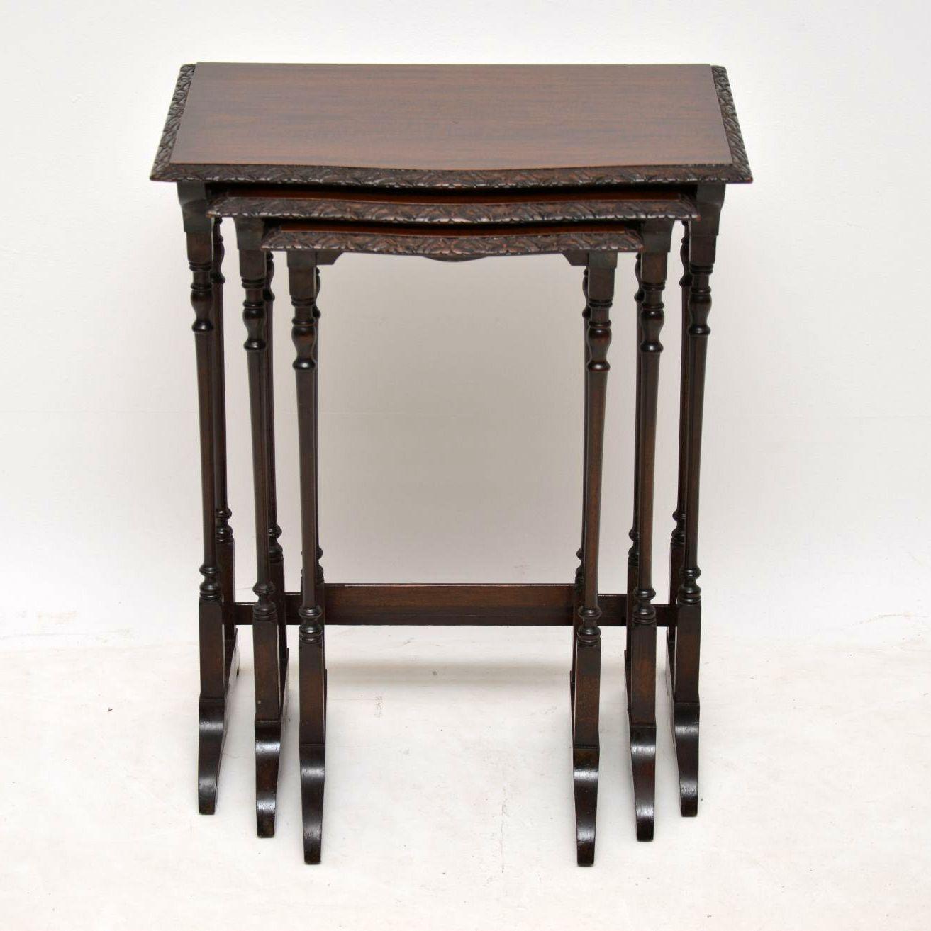 Antique Edwardian mahogany nest of three tables dating to circa 1900-1910 period and in good original condition. The serpentine shaped table tops have finely carved edges and there are stretchers across the backs of the legs providing greater