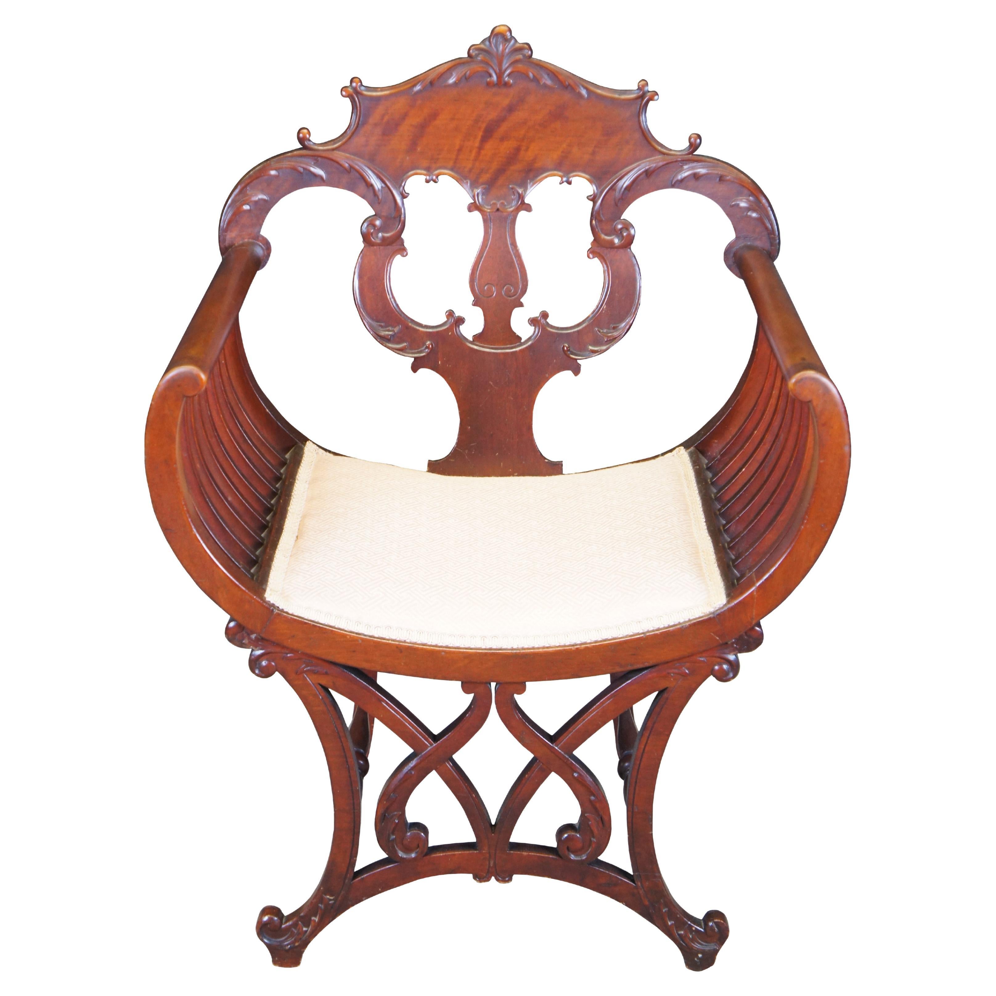 Antique Spanish Revival mahogany curule / Savonarola style / throne / saddle seat arm chair featuring a pierced and slatted design with acanthus accents.

Dimensions:
25