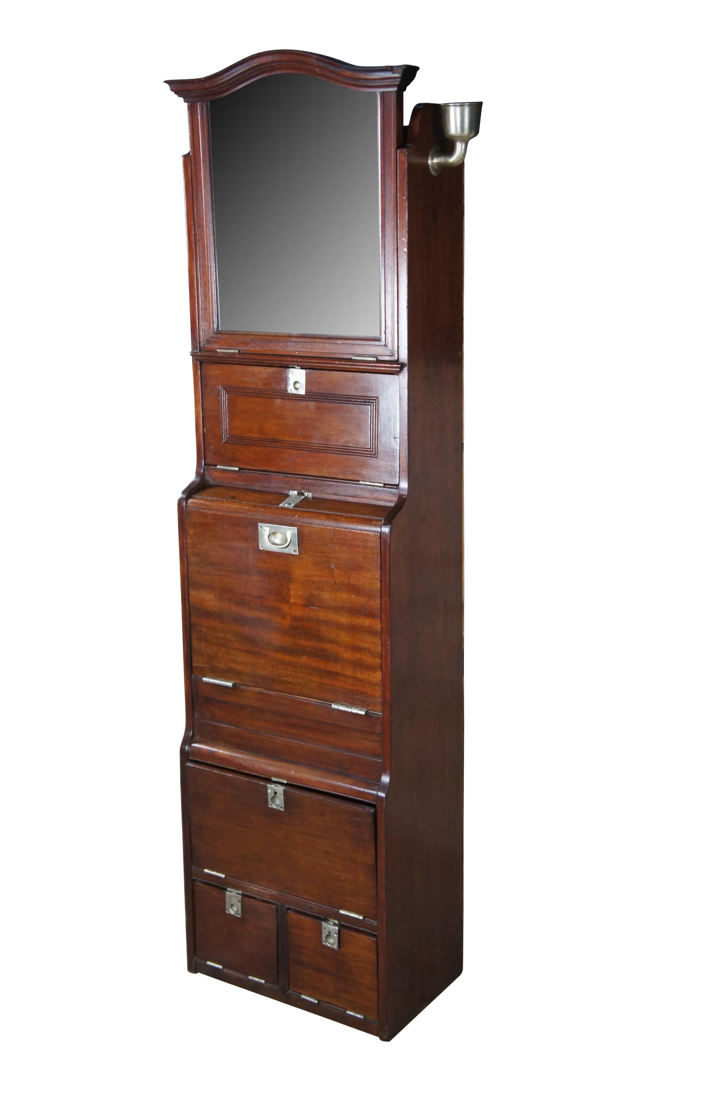 Antique nautical maritime boat / ship / steamship first class cloakroom compactum cabinet with porcelain wash basin and extras.  Made of mahogany featuring overhead adjustable mirror with multiple storage cabinets / cubbies.


Dimensions:
12.5