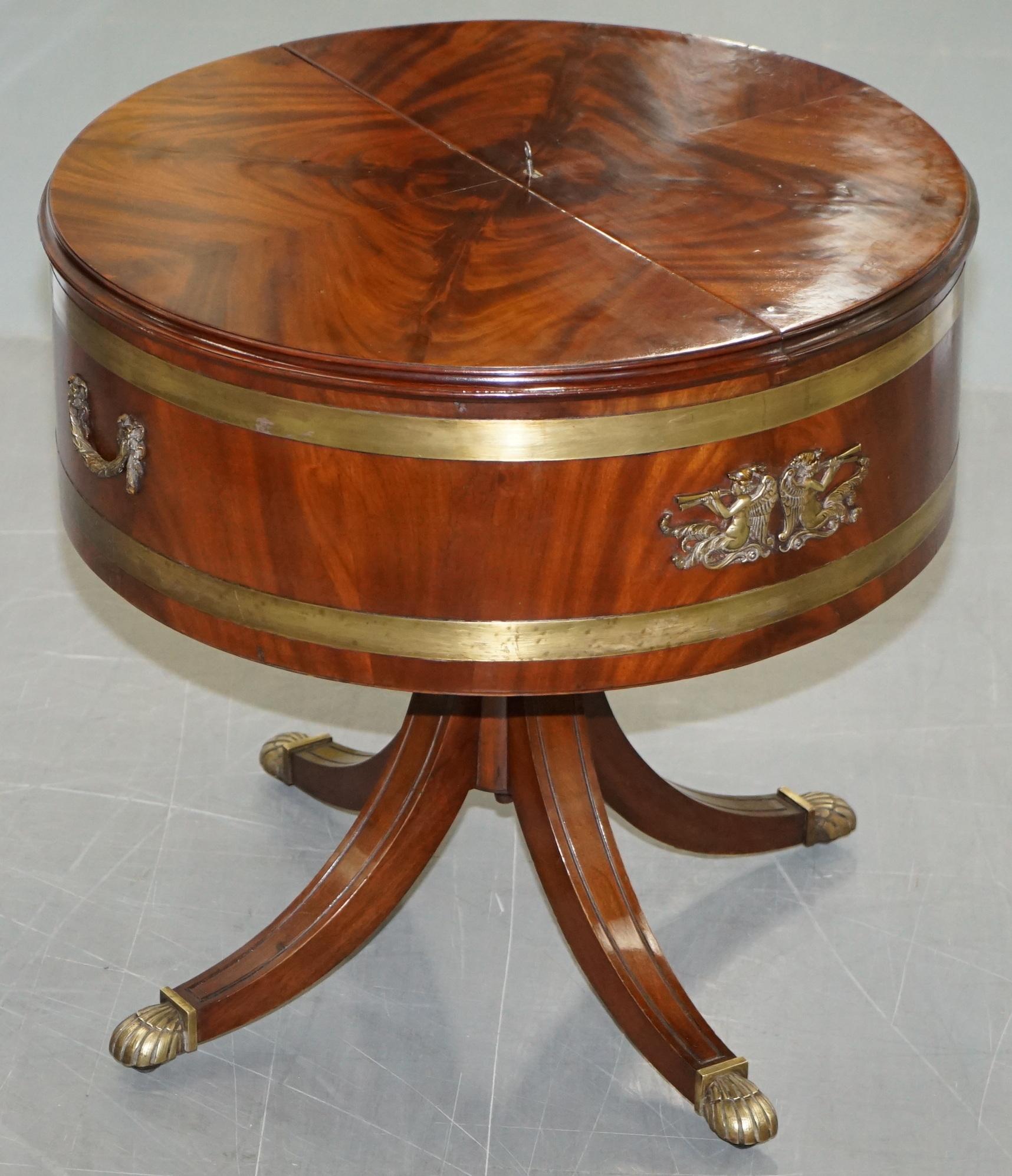 We are delighted to offer for sale this really quite rare restored Regency Empire Mahogany with original bronze fittings and brass trim drum side table with hidden drinks cabinet

A really very good looking antique piece in period fully restored