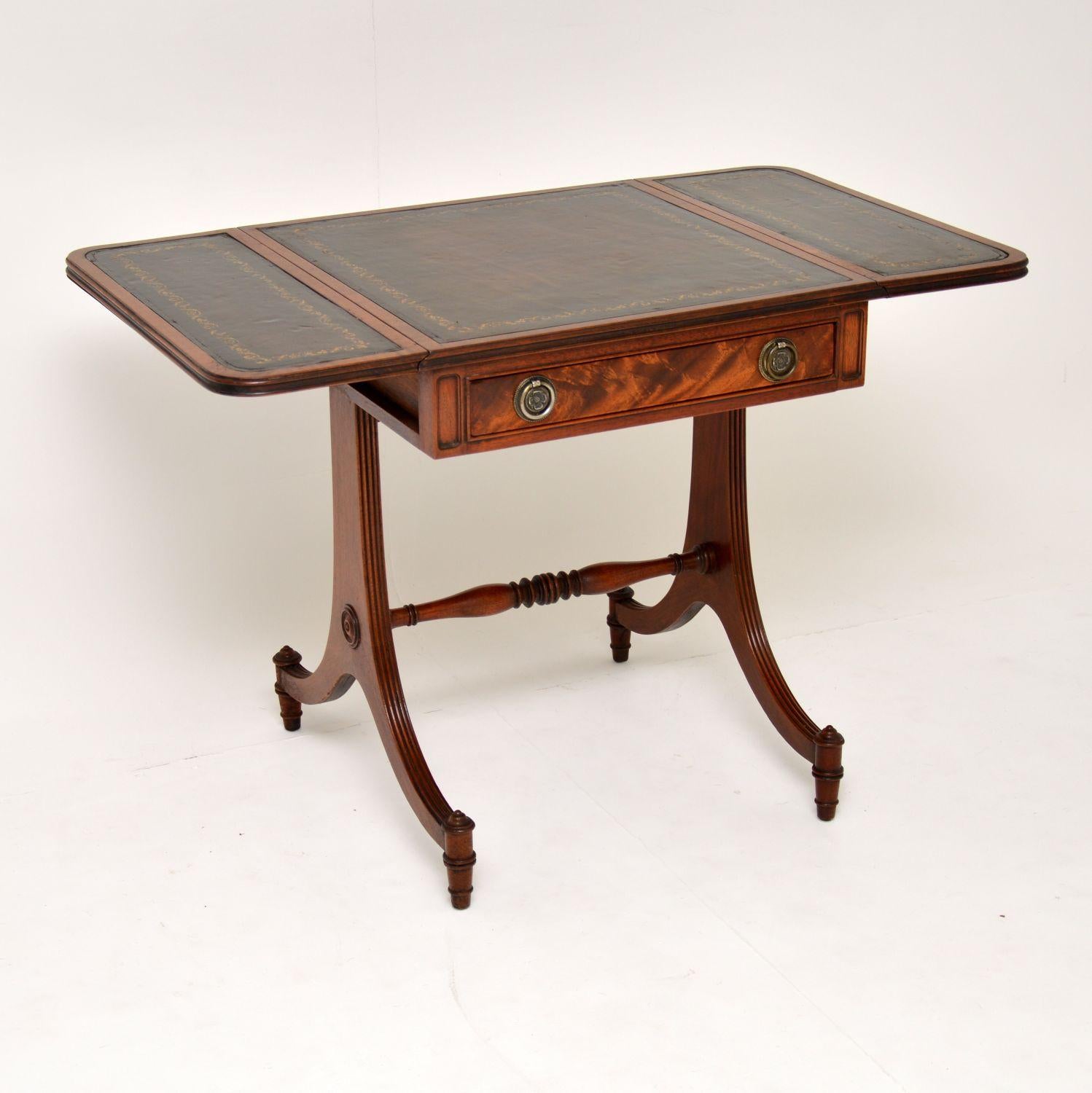Antique Regency style mahogany drop-leaf side table with tooled leather insets on the top surfaces.

It’s fine quality, in very good condition and dates to circa 1950s period.

There is one drawer on the front with brass handles and a matching