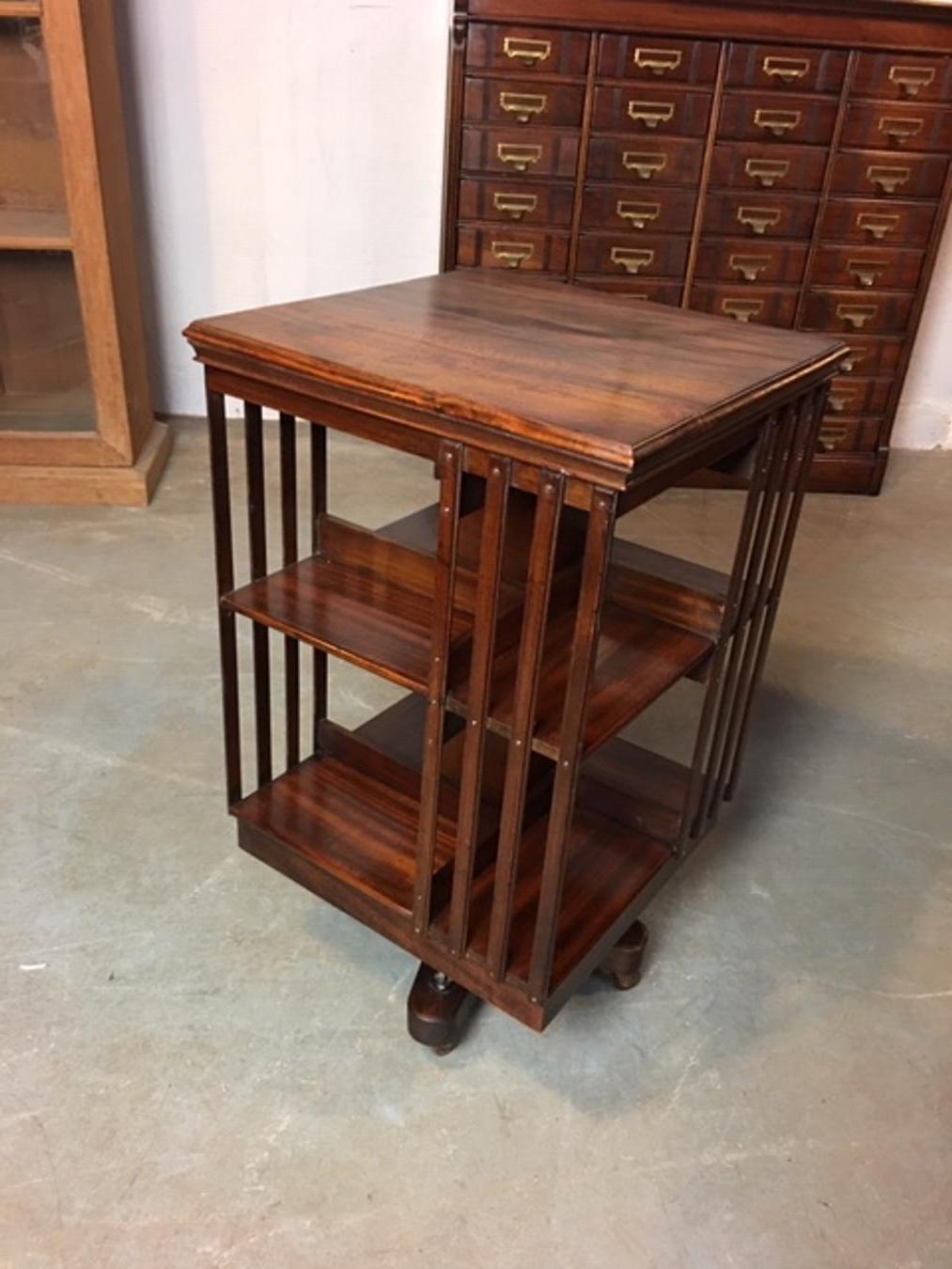 Beautiful mahogany revolving bookcase in good condition. It is a very solid revolving bookcase with a cast iron base. Made circa 1900 by the company Maple & Co. Size: 49cm x 49cm x H 86cm The maker Maple & Co was the most important manufacturer of