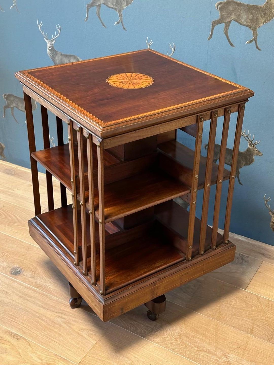 Beautiful antique mahogany book mill with beautiful inlay. Inlaid with satinwood. Super quality book mill from the famous English 19th century furniture maker Maple & Co. with the characteristic cast iron base. Beautiful color and appearance.