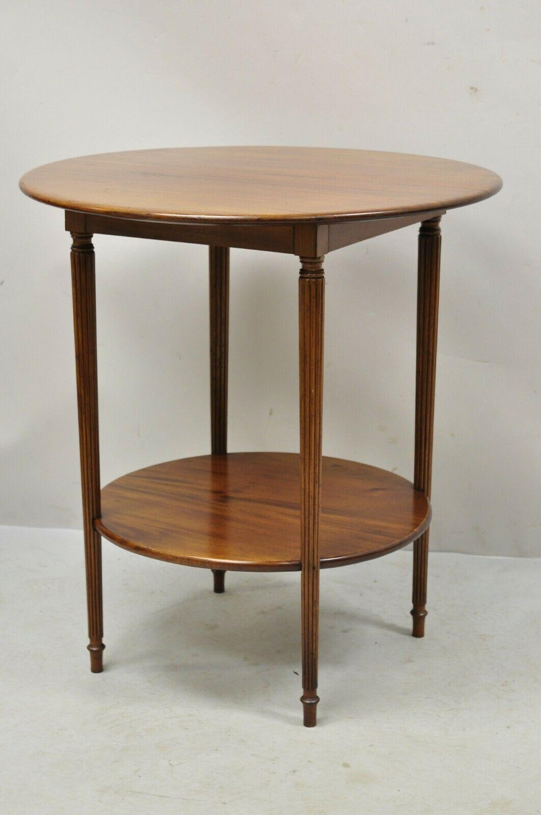 Antique mahogany round 2 tier sheraton accent lamp side table. Item features 2 round tiers, solid wood construction, beautiful wood grain, tapered legs, very nice antique item, great style and form. Circa Early to Mid 20th Century. Measurements: 26