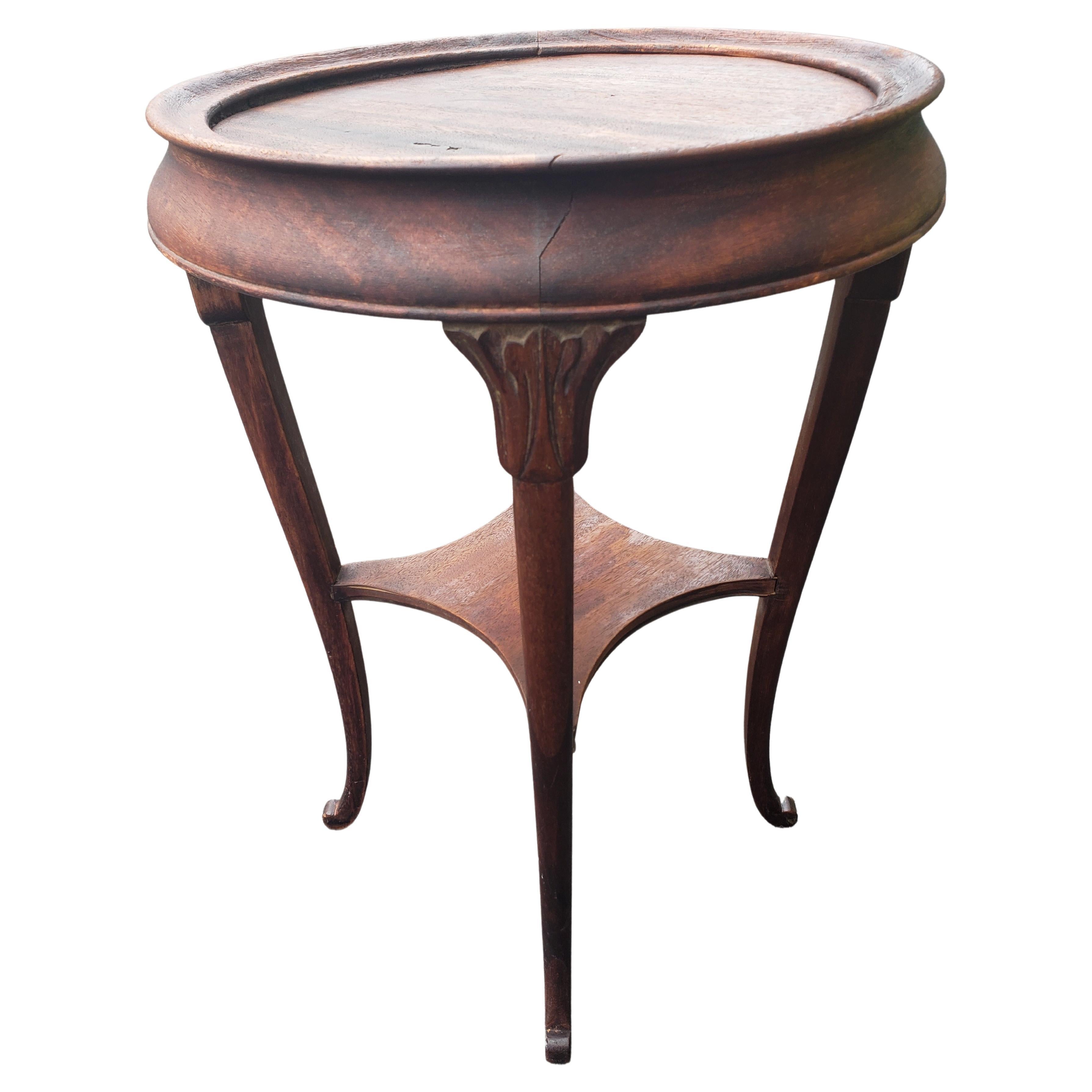 Antique Mahogany round parlor lamp table two tier large plant stand, C 1900s.

Very steady. No wiggles. Wear appropriate with age and use. 

Measures: 16 inches in diameter x 24 inches tall

W5