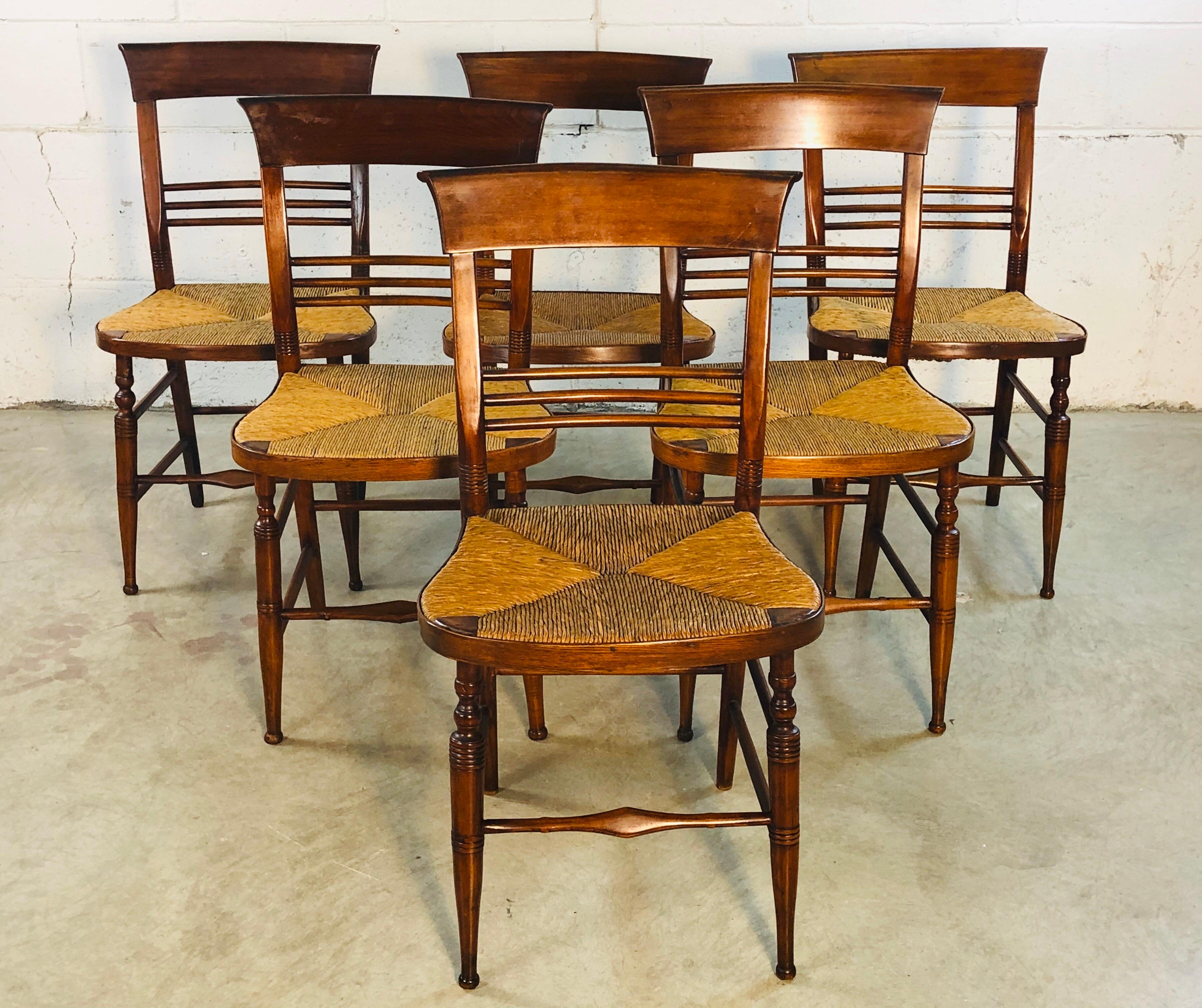 Antique rustic set of 6 mahogany rush seat dining chairs. A great set of sturdy chairs with the seats in excellent condition. Handmade craftsmanship with great design. Well cared for over the years and not abused. Excellent used condition with no