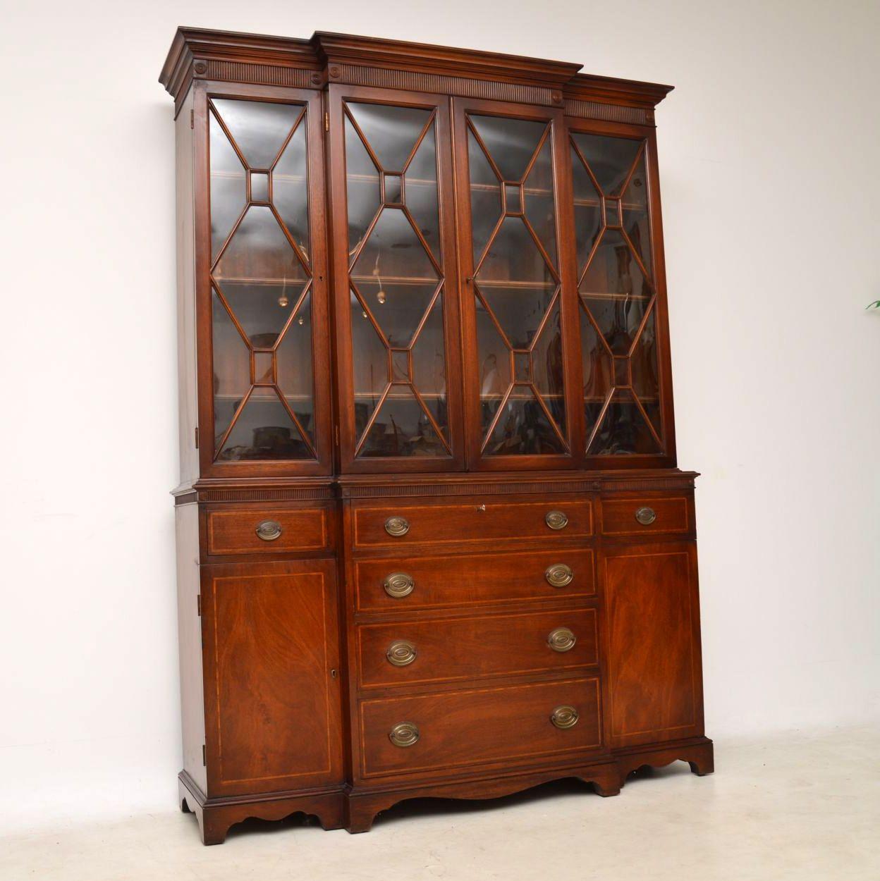 High quality antique secretaire breakfront mahogany bookcase in excellent condition and with some wonderful features. I don't know if you can see in the images, but if you enlarge you will just make out that the glass panels are all slightly curved
