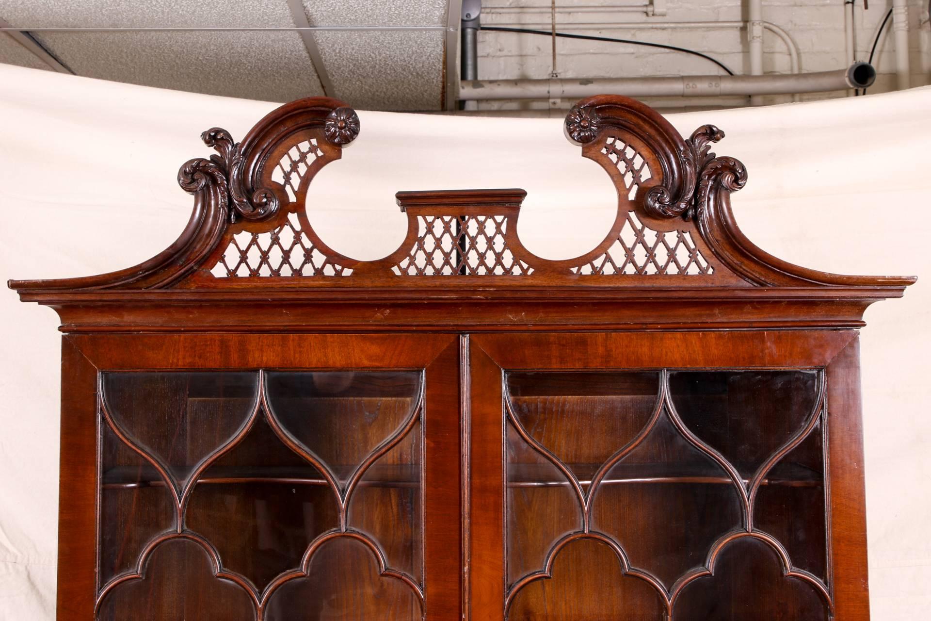 Ancienne bibliothèque de secrétaire avec portes en verre à meneaux:: en acajou:: la partie supérieure avec un capot ajouré à volutes au-dessus de doubles portes à meneaux s'ouvrant sur deux étagères en forme et une autre étagère au-dessus de doubles