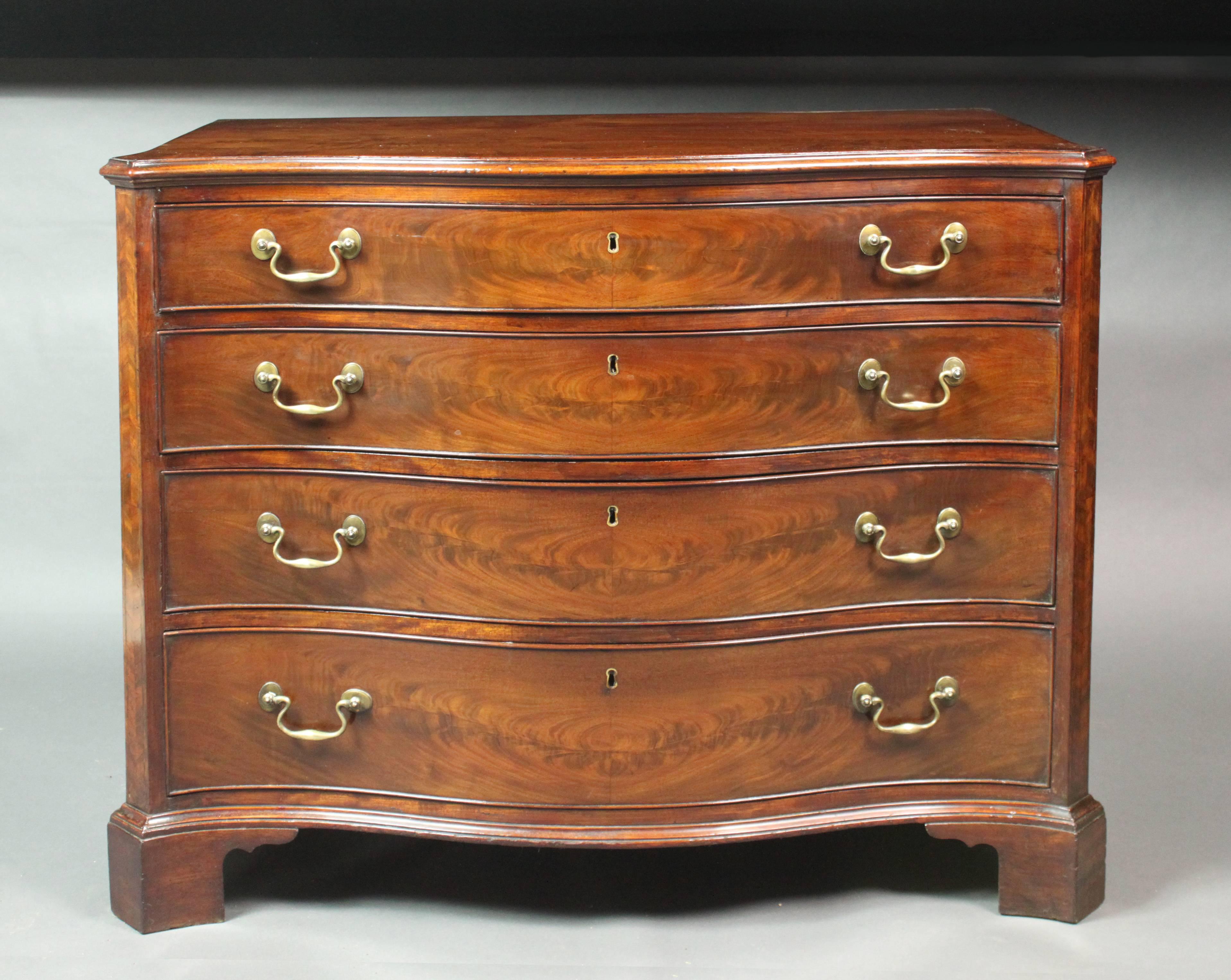 A fine George III serpentine-front Chippendale period commode in superb figured mahogany. Good model: canted corners with herringbone inlay, shaped sides, panelled back, original handles and bracket feet; the top drawer with brushing slide and