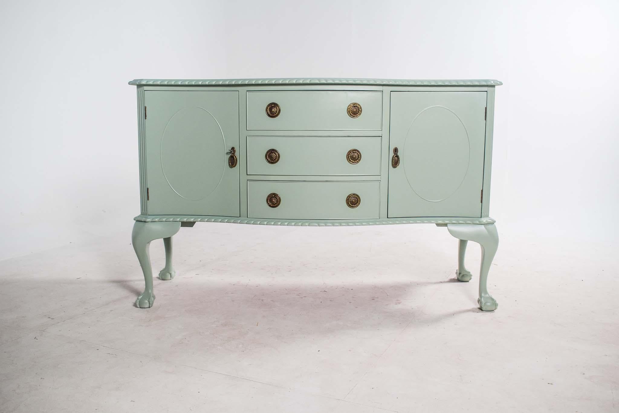 This Shabby Chic sideboard is a restored piece of fine craftsmanship, blending elegance with a rustic charm. Originally made from high-quality mahogany, the furniture now has a distressed finish that gives it a vintage, well-worn look, perfect for