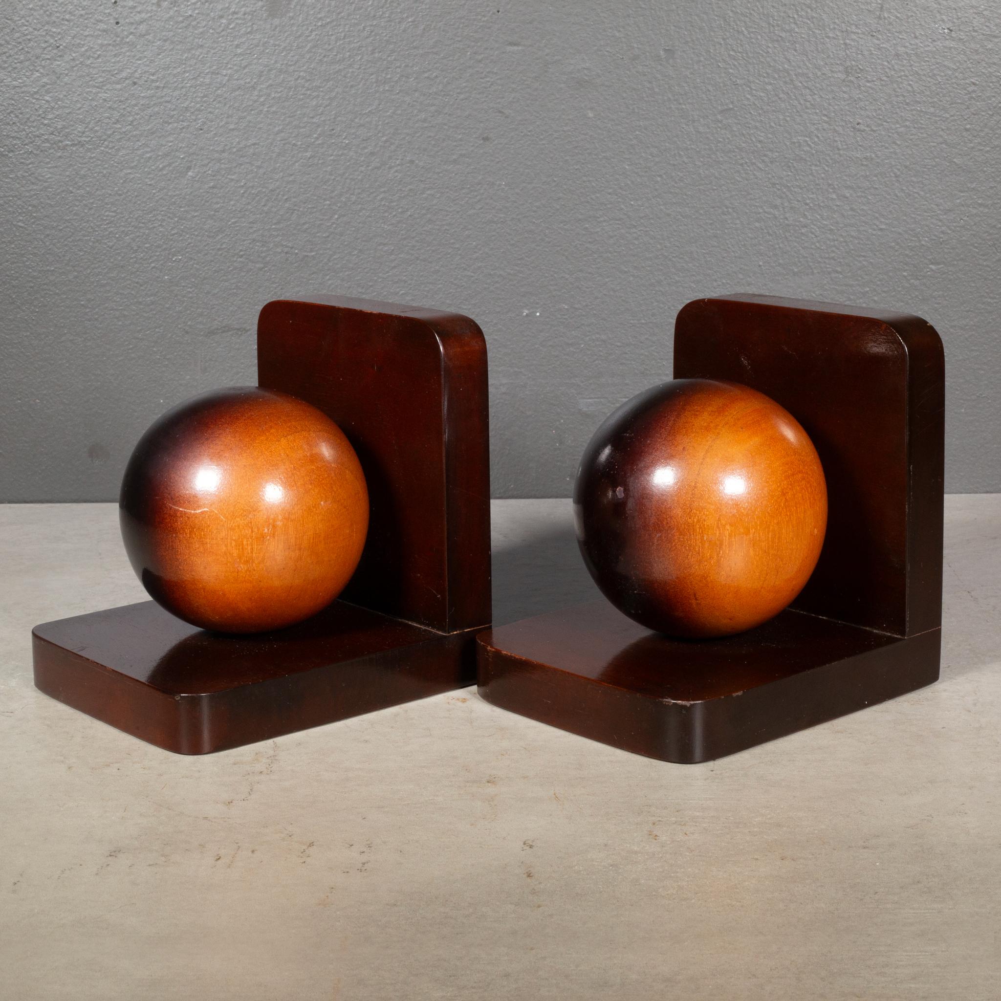 ABOUT

Pair of solid Mahogany sphere bookends with original San Juan, Puerto Rico stickers.

    CREATOR Unknown. Puerto Rico. 
    DATE OF MANUFACTURE c.1930-1950.
    MATERIALS AND TECHNIQUES West Indies Mahogany. 
    CONDITION Good. Wear