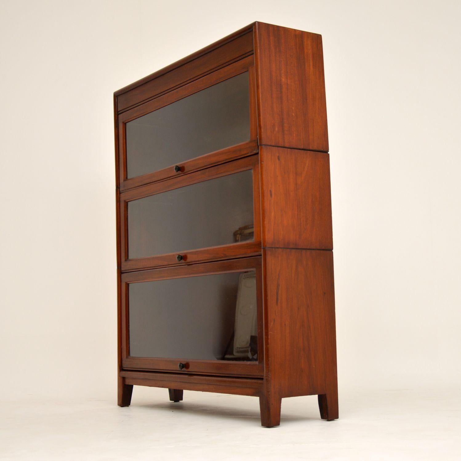 Antique mahogany stacking bookcase, which comes apart into three sections for easy transportation. It dates from the 1920s period and is in excellent condition. As you can see, the glass fronted doors lift up and simply slide back to allow good