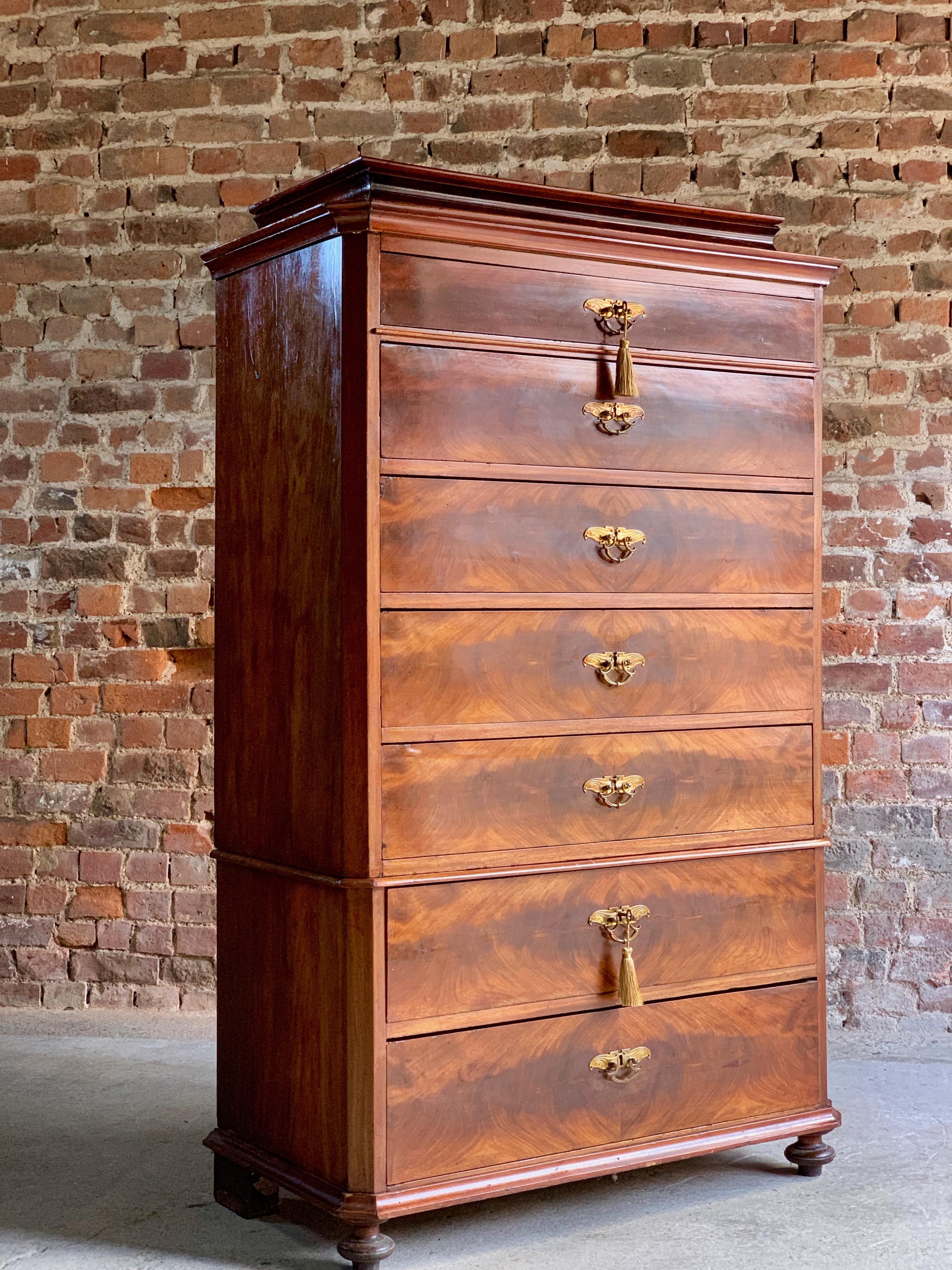 Antique mahogany tallboy chest of drawers 19th century Danish Biedermeier style.

Magnificent antique 19th century Danish flame fronted mahogany tallboy chest of drawers in the Biedermeier style circa 1880, the canted top over seven graduated