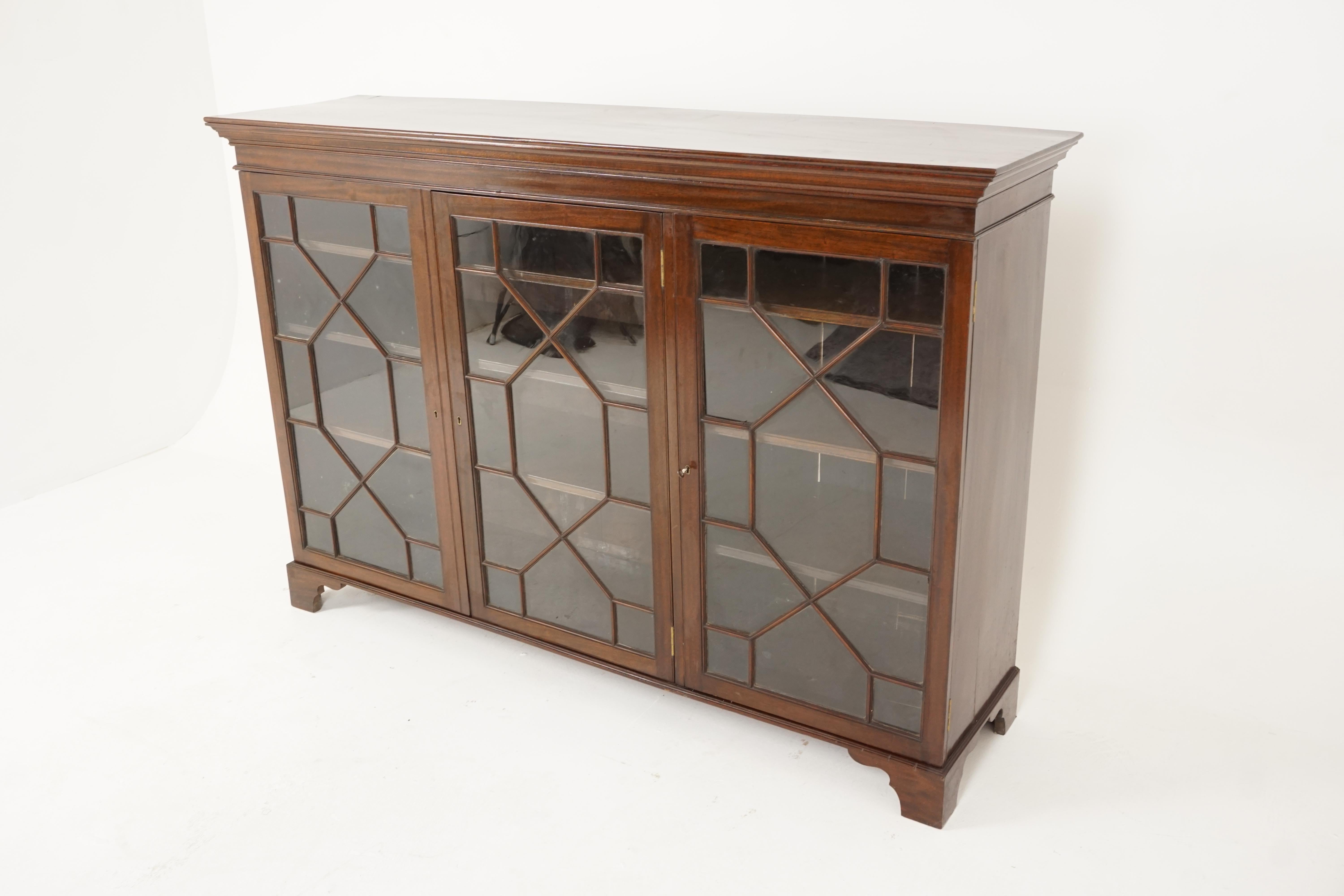 Antique Walnut three door bookcase display cabinet, Scotland 1920, B2409

Scotland, 1920
Solid Walnut
Original finish
Rectangular moulded top
Three glass doors with geometric moulding to the front
Opens to reveal double door to the left and single