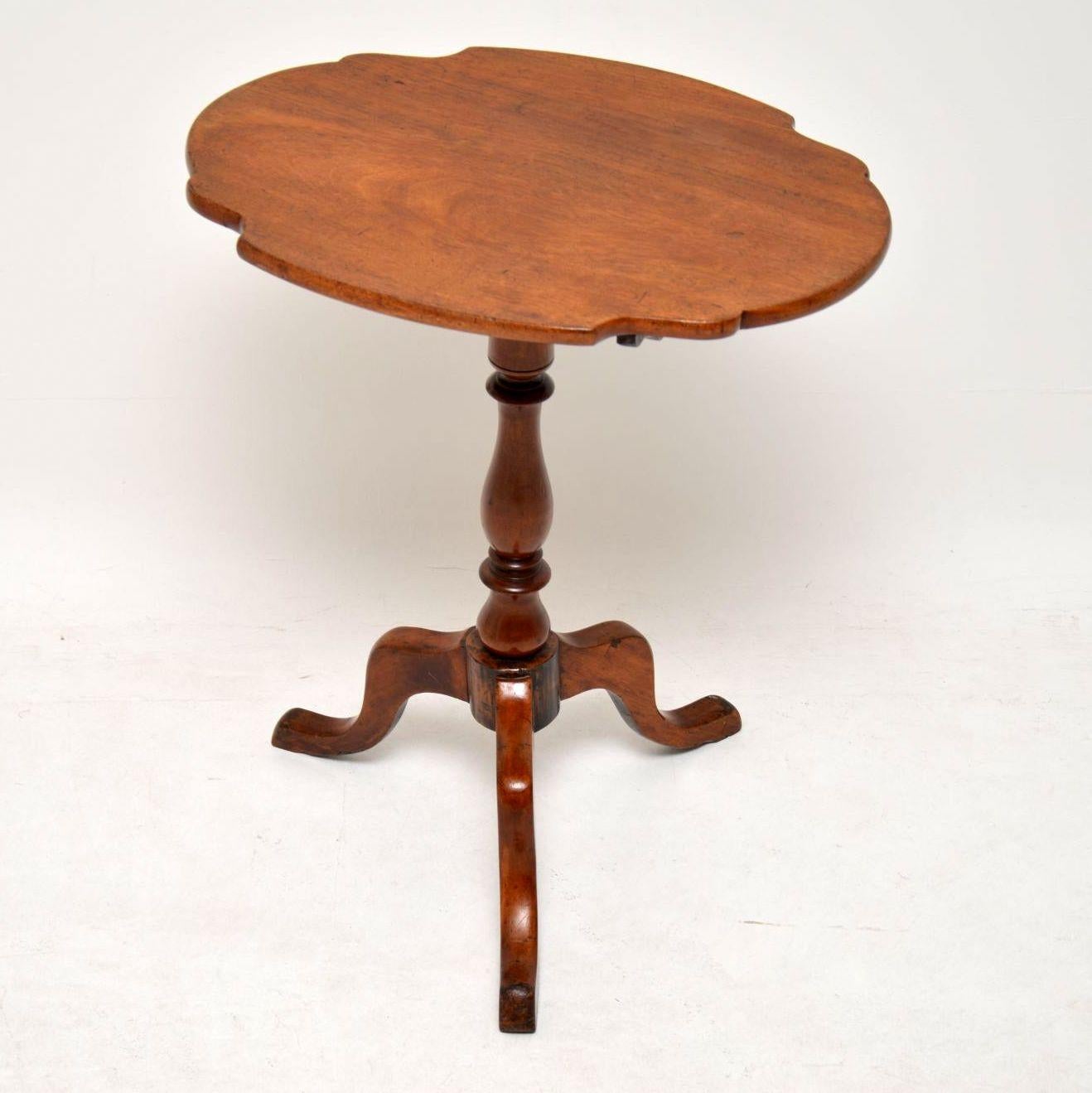 This antique solid mahogany tilt-top table has a lovely color and is full of character. It has a shaped top which can be tilted up and sits on a turned column with tripod legs. I can’t work out if it’s Georgian or Victorian, so lets say it’s from