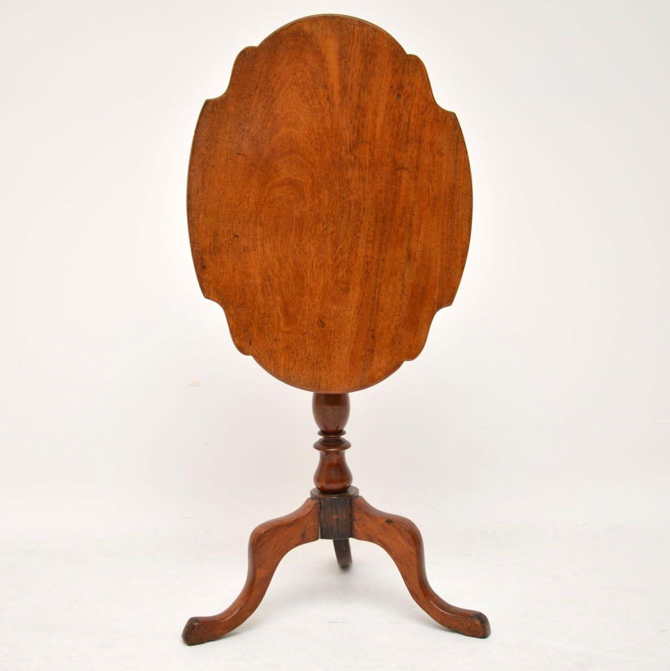 This antique solid mahogany tilt-top table has a lovely color and is full of character. It has a shaped top which can be tilted up and sits on a turned column with tripod legs. I can’t work out if it’s Georgian or Victorian, so let’s say it’s from