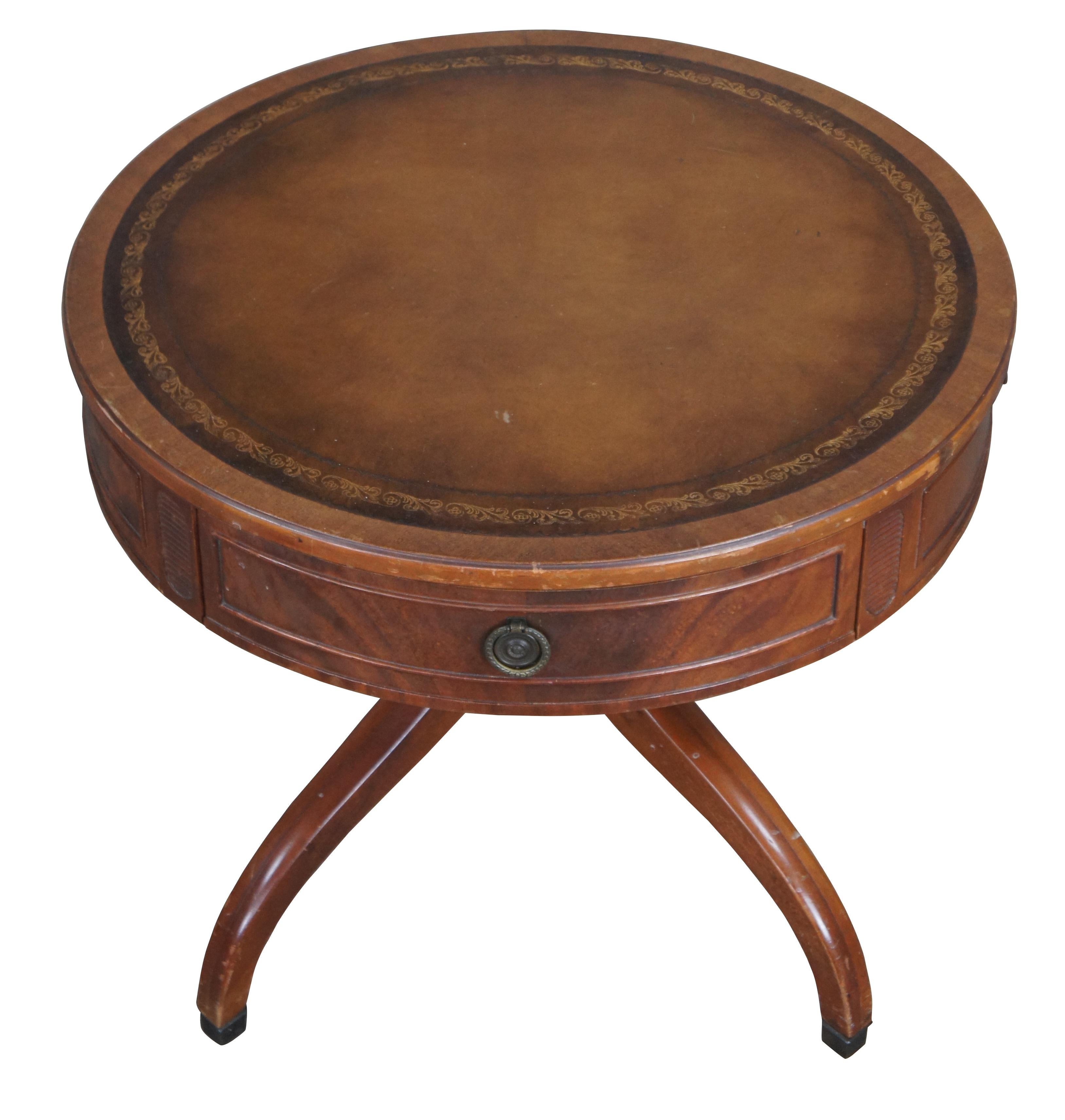 Antique round Regency style drum pedestal table.  Made of mahogany featuring a tooled leather top with one drawer, supported by four serpentine legs.

Dimensions:
24
