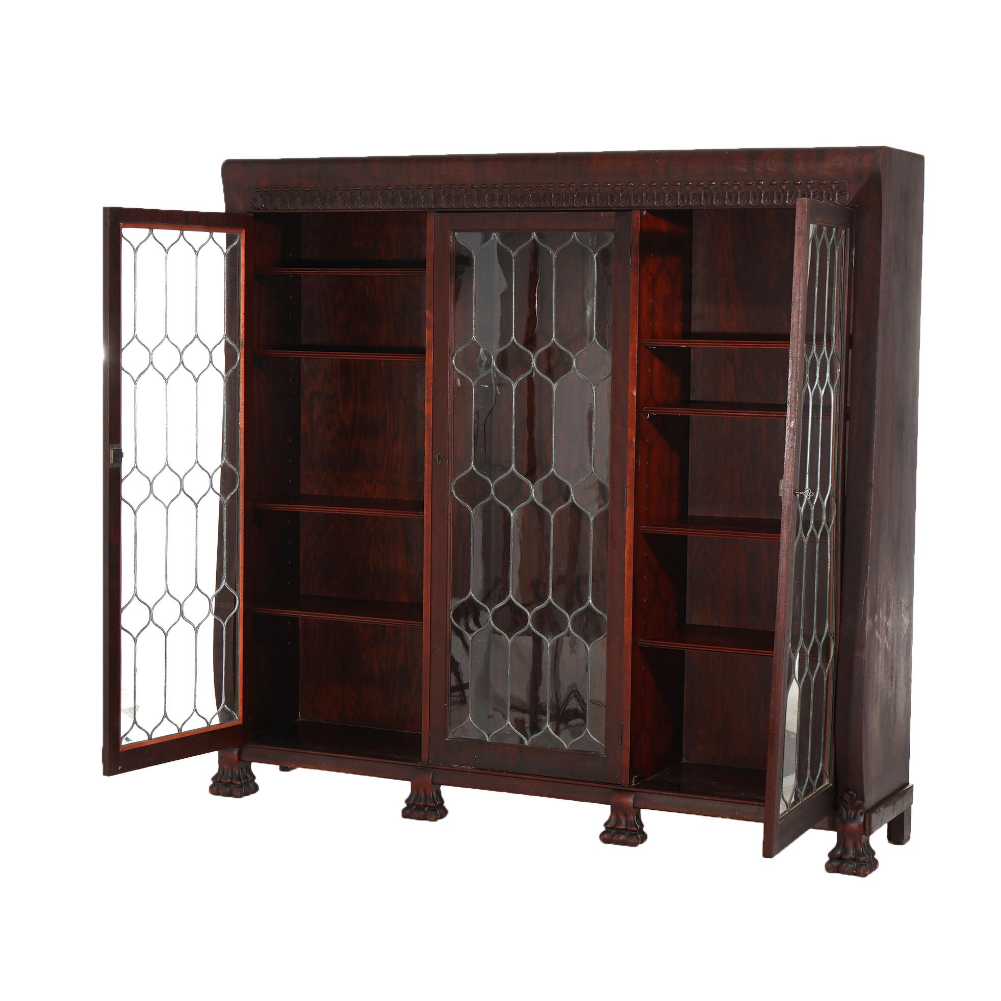 ***Ask About Reduced In-House Shipping Rates - Reliable Service & Fully Insured***
An antique American Empire Classical Greco bookcase offers mahogany cosnt4uction with three leaded glass doors opening to a divided and adjustable shelf interior,