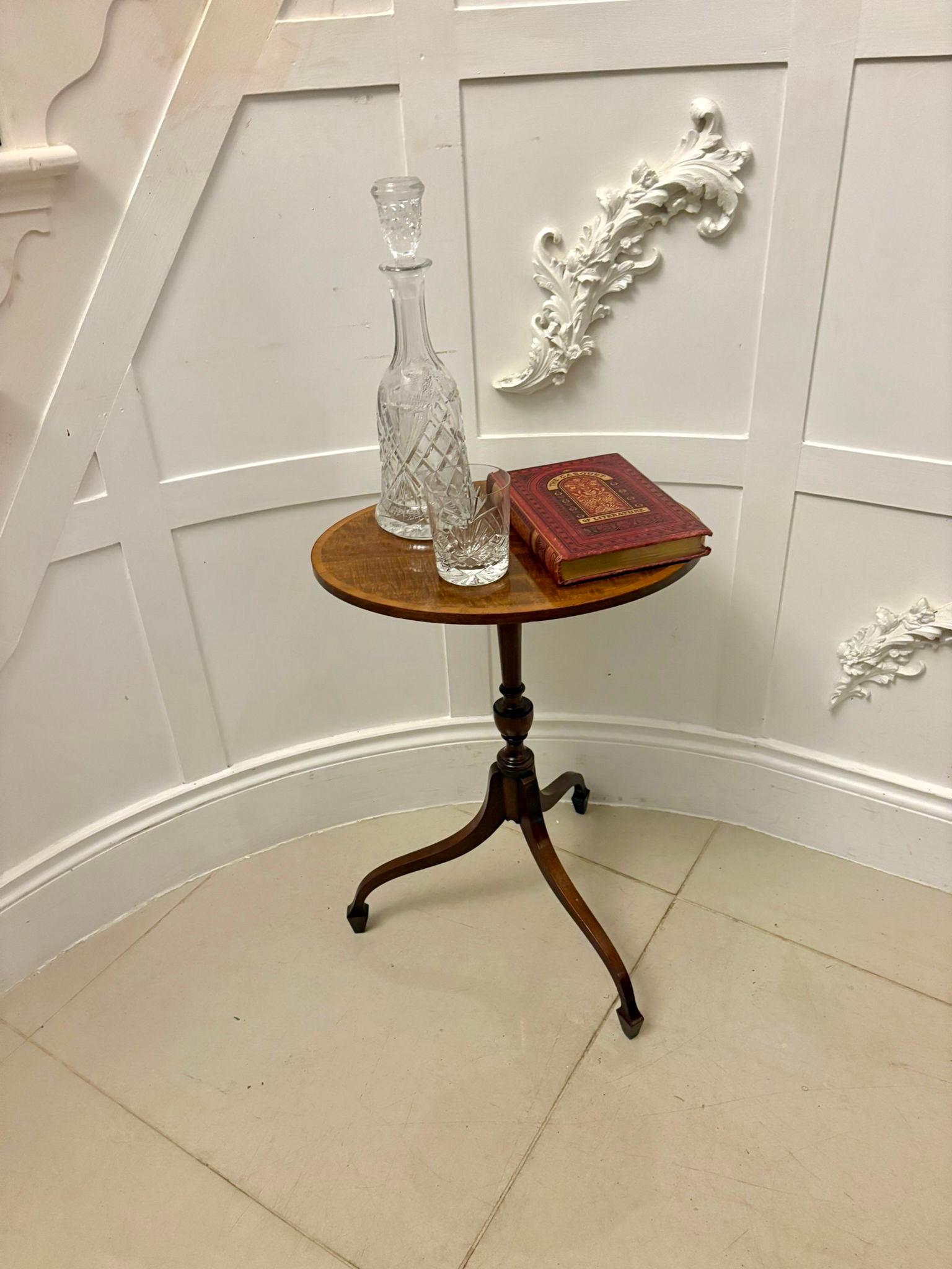 Très belle table à vin ancienne en acajou avec un plateau circulaire magnifiquement figuré et des bandes transversales en bois de satin qui ajoutent un contraste raffiné et soulignent la qualité de la pièce. La colonne centrale bien tournée repose