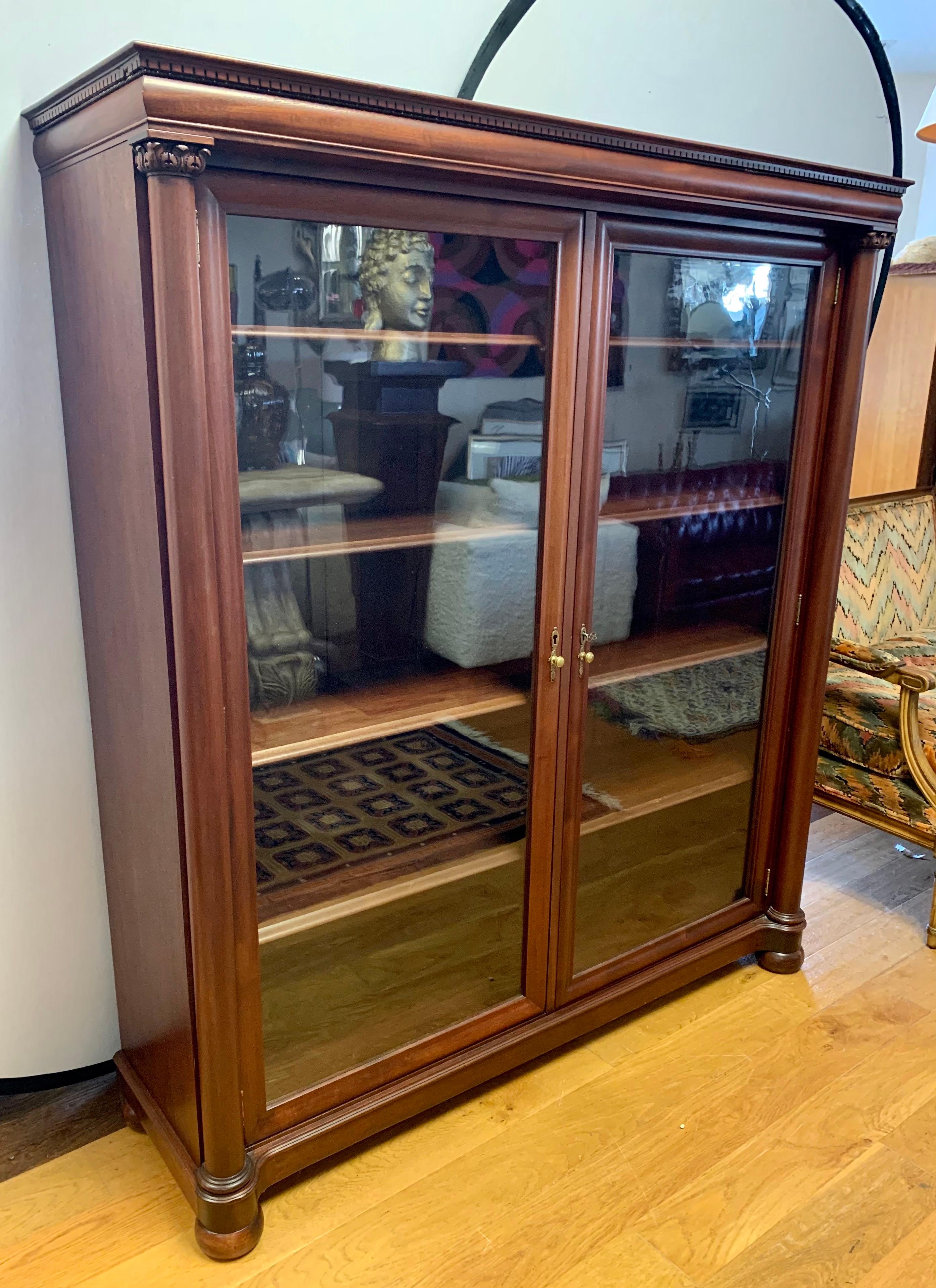 Large handsome mahogany bookcase or display cabinet with two glass doors that open to four adjustable shelves. With working lock and key. Use as a bookcase or cabinet to display your collectibles.