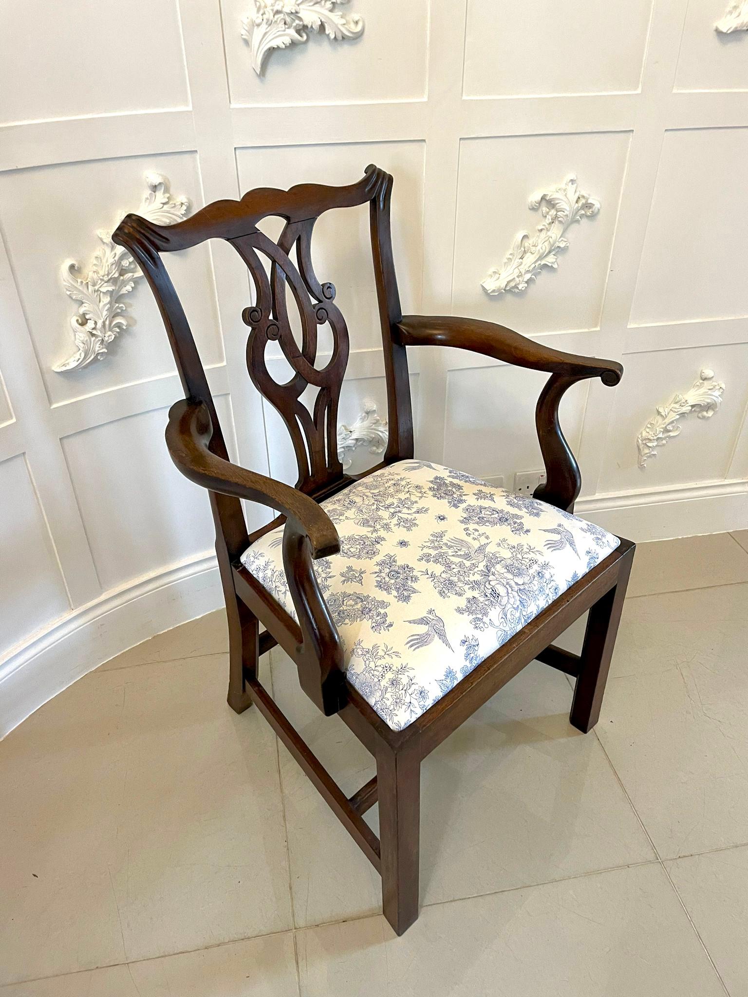 Antique mahogany Victorian desk chair having an attractive shaped top rail and carved splat to the centre, shaped mahogany open arms with a newly reupholstered drop in seat in a quality fabric, mahogany frieze standing on square legs to the front