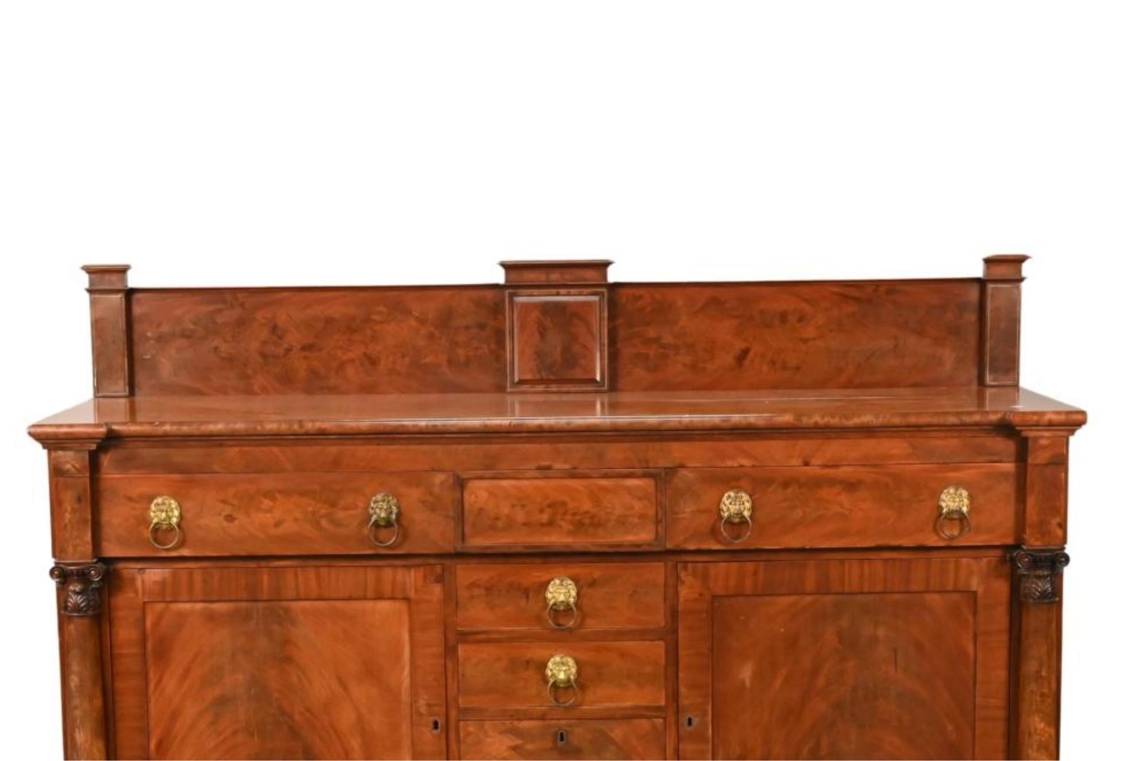 Elevate your dining space with this exquisite Early 19th Century Mahogany Wood Federal Style Sideboard/Credenza with a charming backsplash over a shaped top. Crafted in the distinguished Federal style, this sideboard exudes timeless elegance and