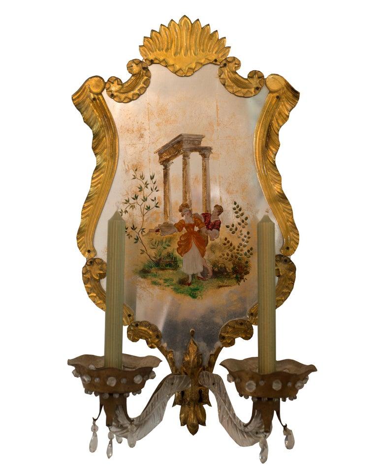 Vintage Maison Jansen Verre Eglomise and Murano wall sconces. They are delicately painted and surrounded with Murano glass and would be equally appropriate in a contemporary or traditional home. Perfect for a powder room or woman’s bathroom. Can be