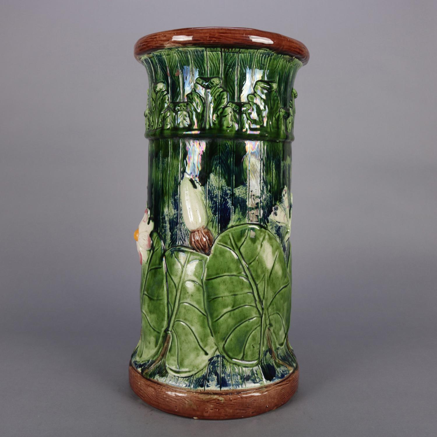 Antique Italian Majolica Aesthetic Movement art pottery umbrella stand features hand painted high relief pond or marsh scene with lily pads, dragonfly and butterfly decoration, circa 1870.

Measures: 10