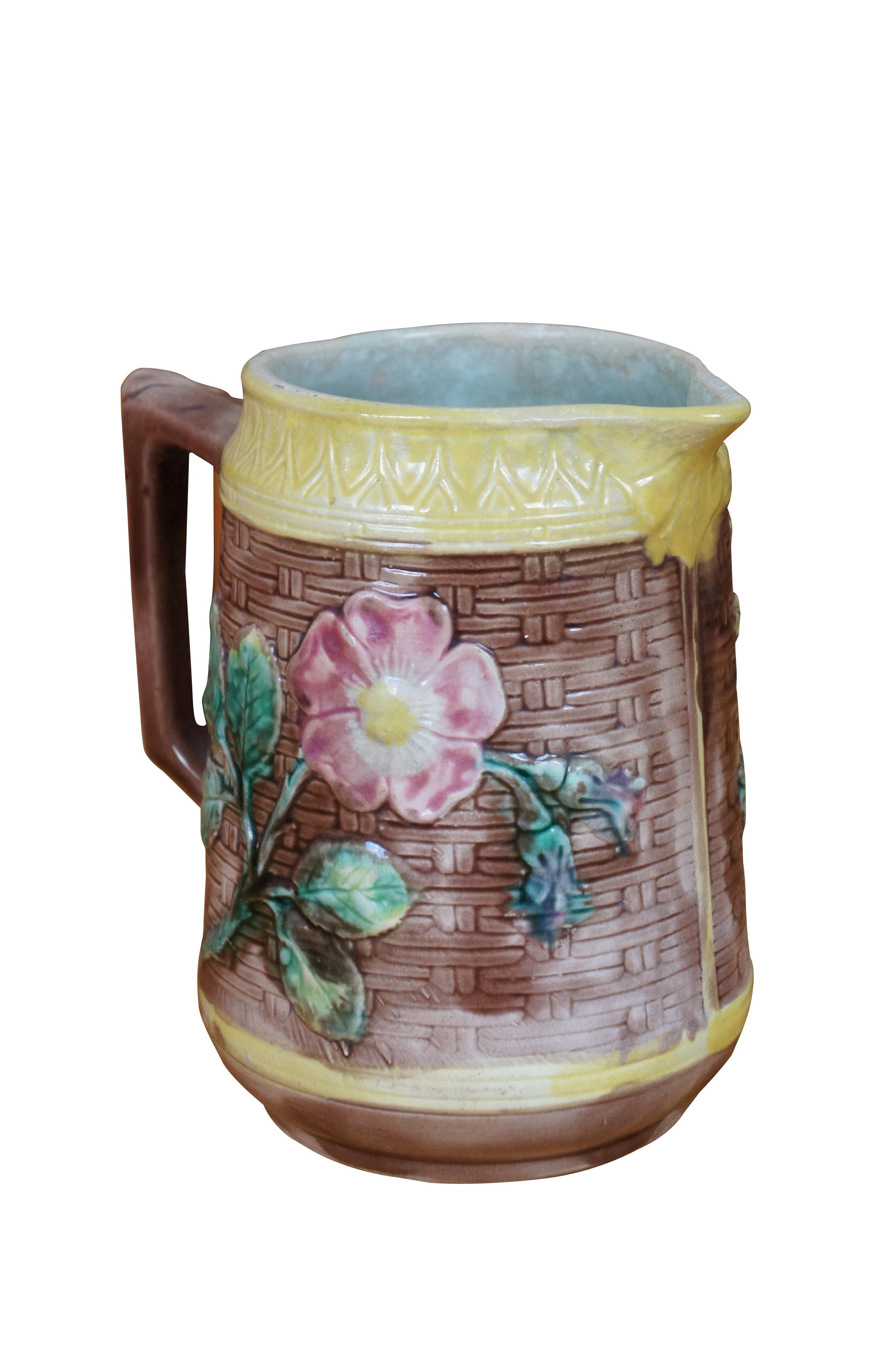 Antique Majolica creamer pitcher / jug featuring a farmhouse motif with wood grain basket weave design, Sunflowers, wild dogwood flowers and acanthus handle.

Dimensions:
6.5