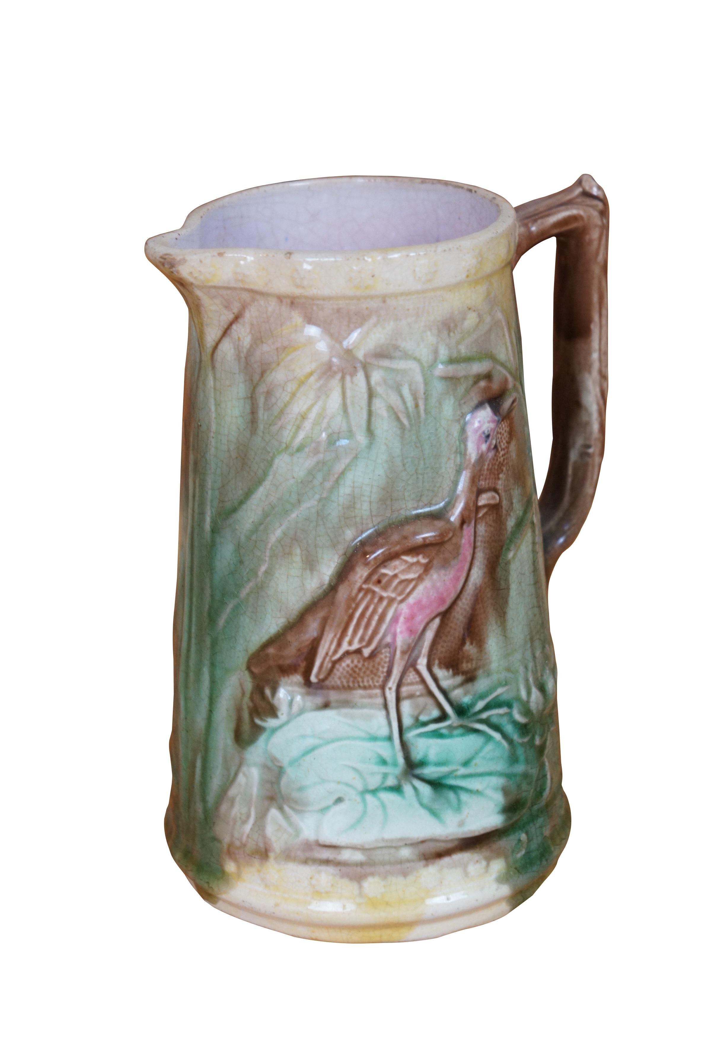 Antique Majolica Heron / Crane / Stork creamer pitcher / jug featuring the bird eating a fish on a water lily pad.


Dimensions:
5.25