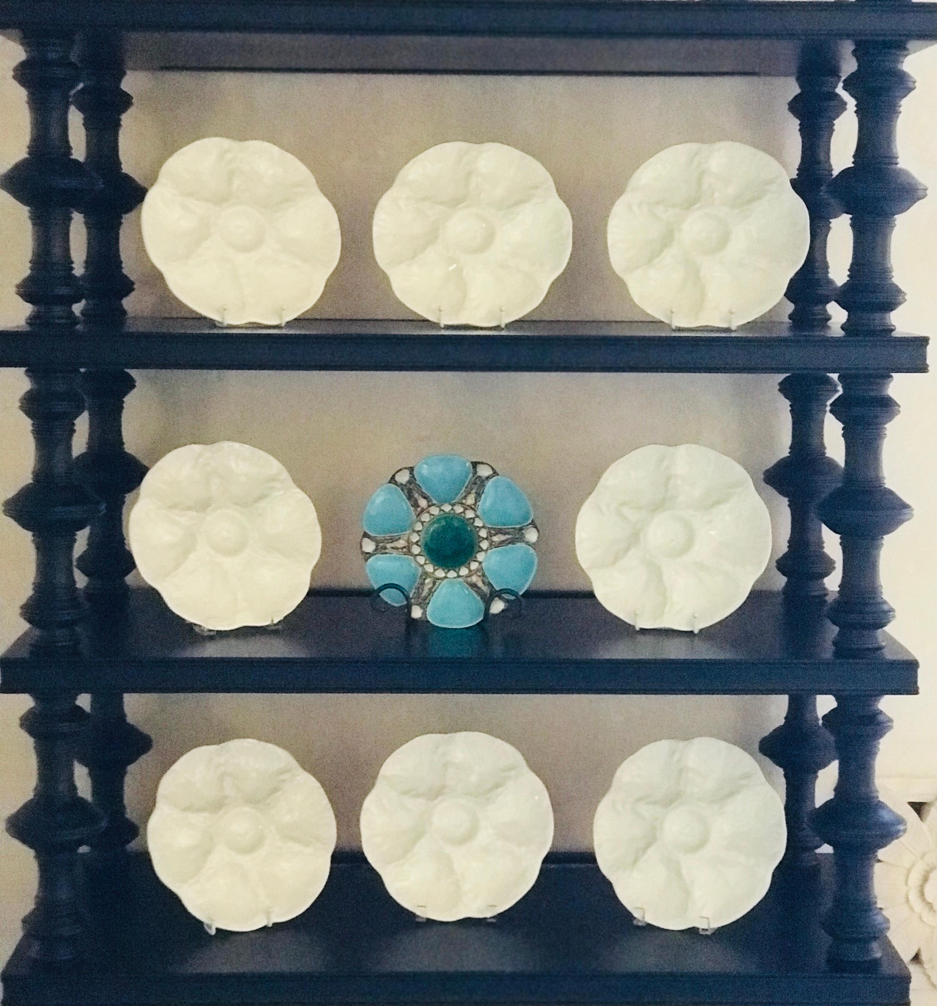 Antique Majolica Turquoise Oyster plate made by Minton in England in the 1867. The mold is 1323 and is stamped on the back along with Minton and the English registry stamp dating the plate to March 20, 1867. 

Each of the six wells is separated in