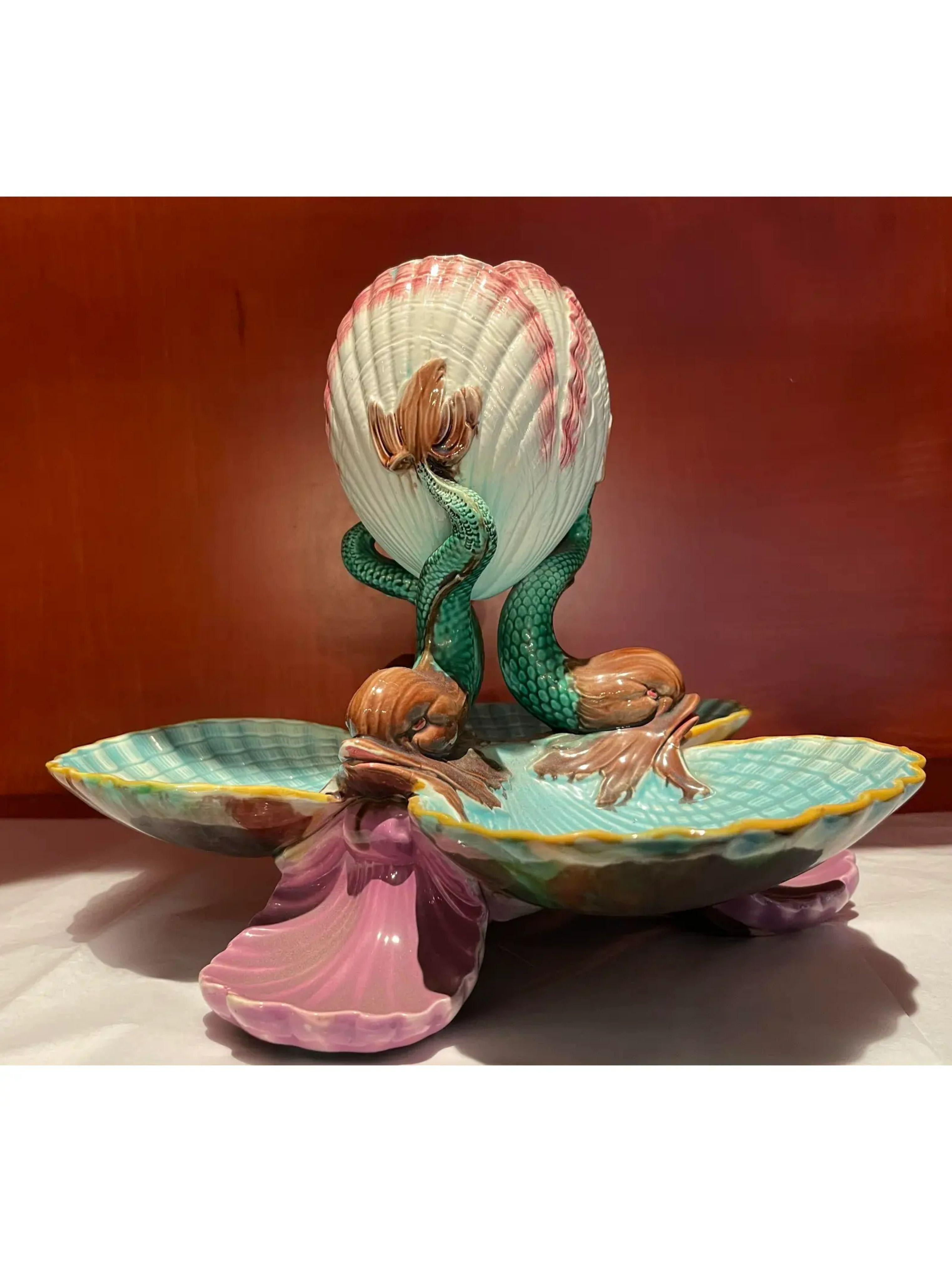 Very rare Antique Majolica pottery dolphin and shell centerpiece bowl. It is a very rare example and features a triple dolphin base, each dolphin flanked by beautifully formed seashells. The structure is topped off by a triple shell form