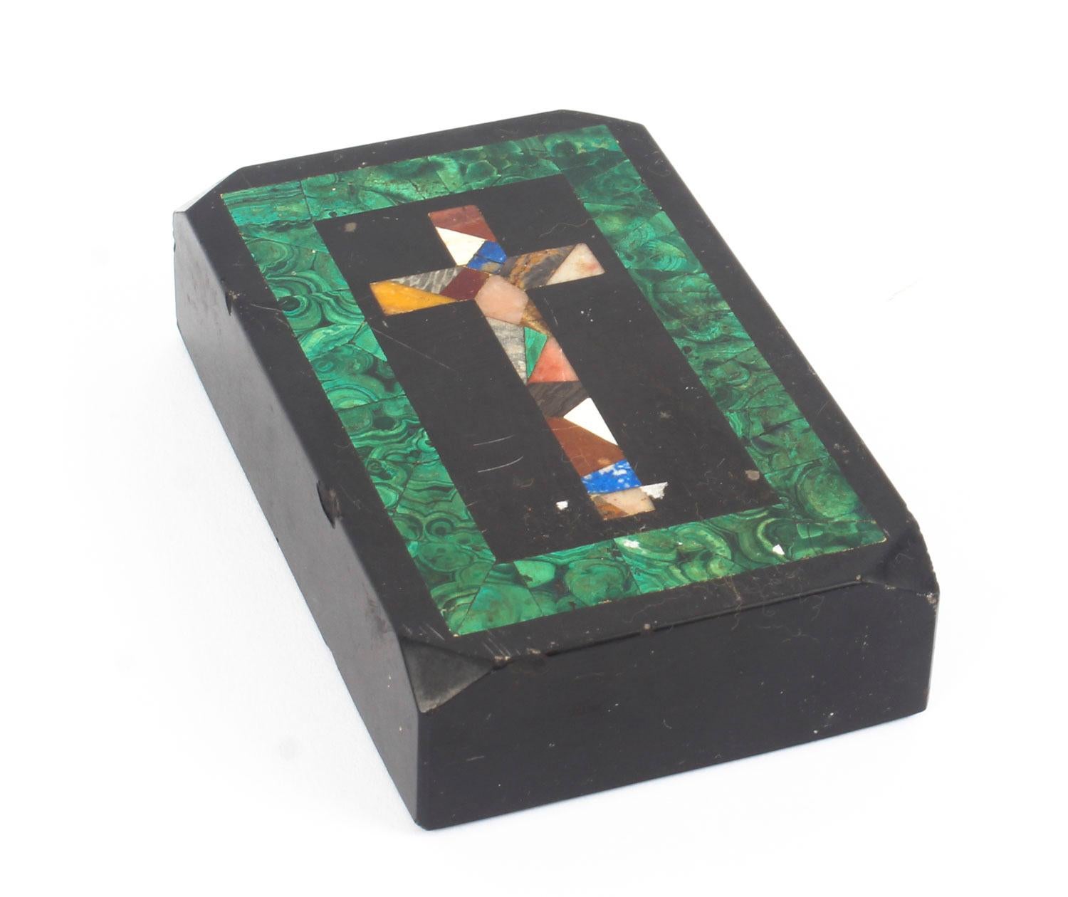 This is a beautiful antique Italian black marble rectangular Pietra Dura paperweight, with chamfered corners.

It is inlaid with a stunning patchwork cross made of semi precious stones within a striking malachite borderwith chamfered