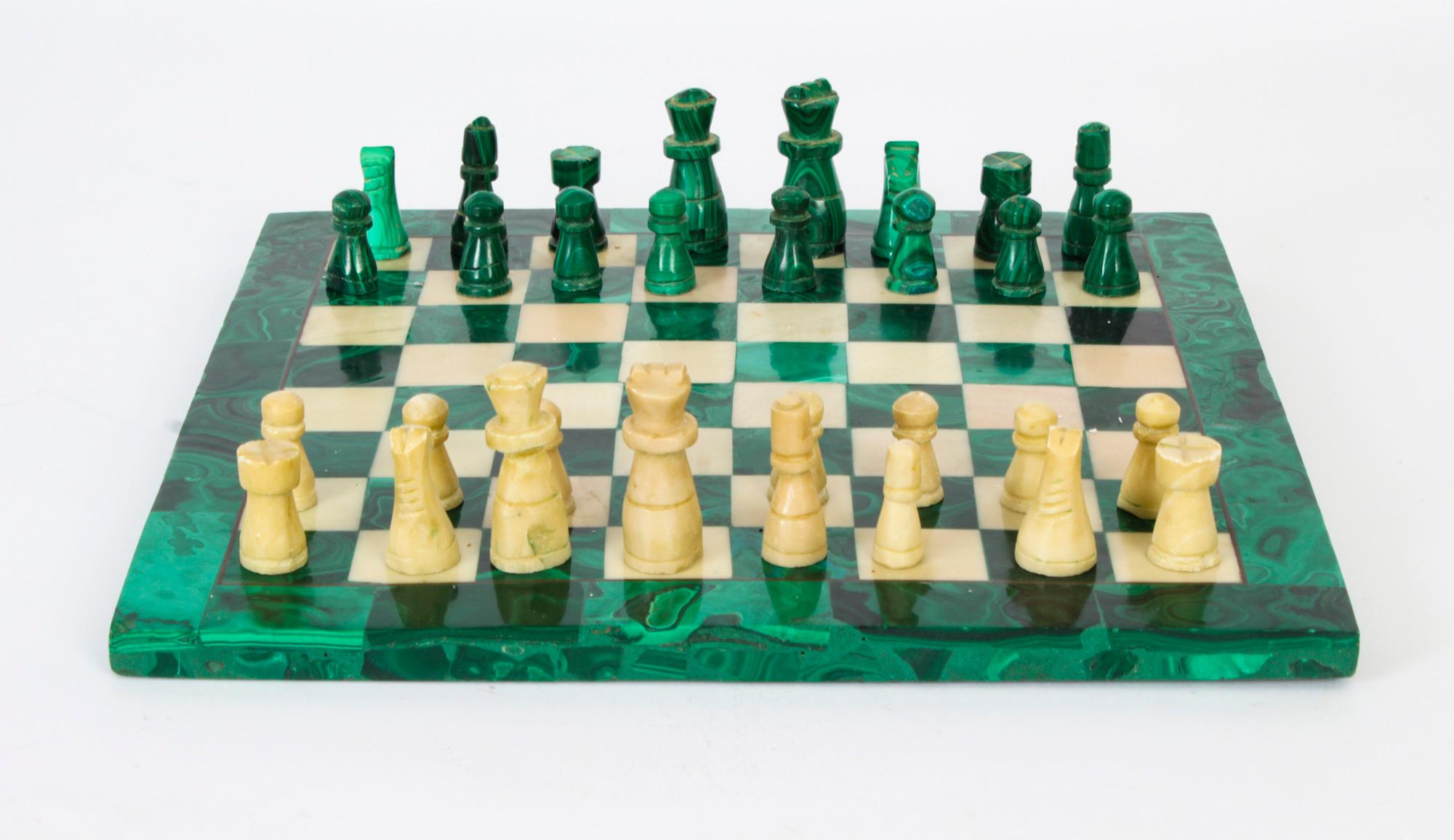 This is a wonderful antique Italian malachite and carrara marble chess board with complete chess pieces, circa 1920 in date.
 
The board is of square form with a malachite border thin inlaid brass stringing around the chess board and pieces of