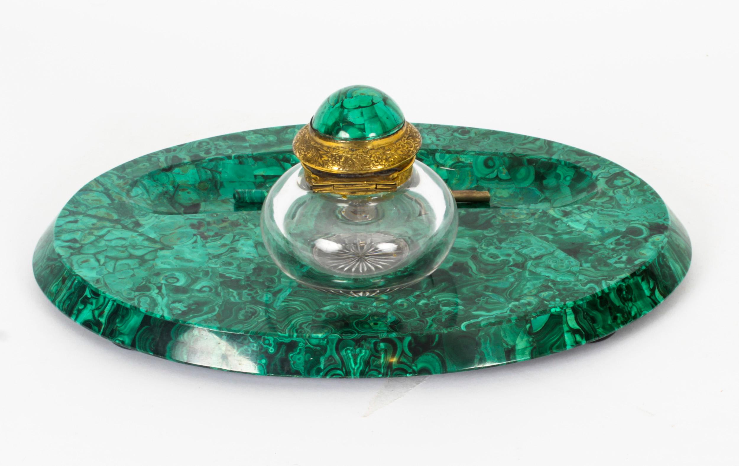 A superb quality Russian malachite mounted desk set, 19th century, comprising an inkwell and Stand and a fountain pen.
 
The bulbous cut glass inkwell with a domed malachite mounted ormolu lid sits on an oval malachite Stand, and the pen sits in