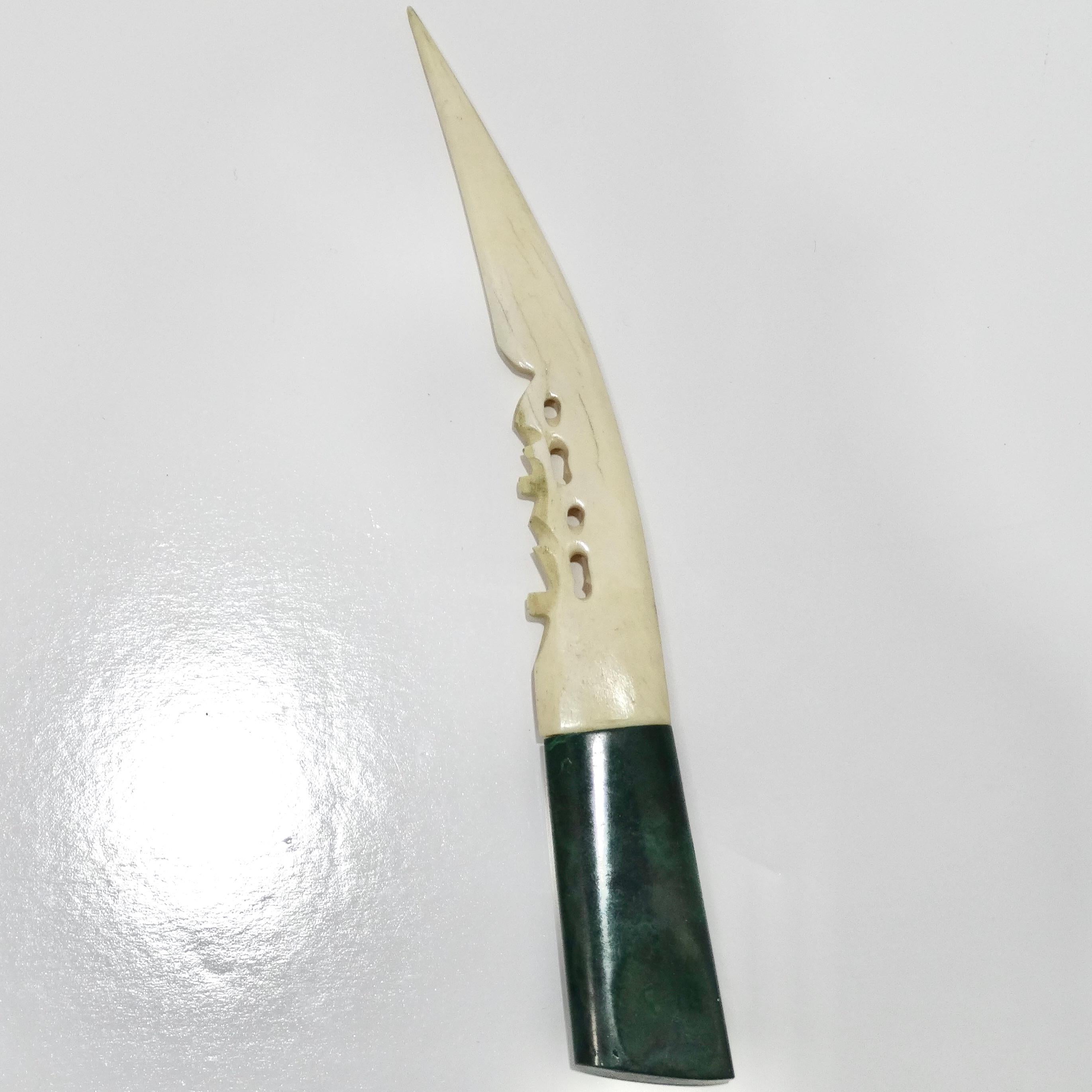 Introducing the Antique Malachite Horn Letter Opener, a magnificent piece from the early 1900s that combines opulent materials with exquisite craftsmanship.

Crafted with meticulous attention to detail, this letter opener features a blade made of