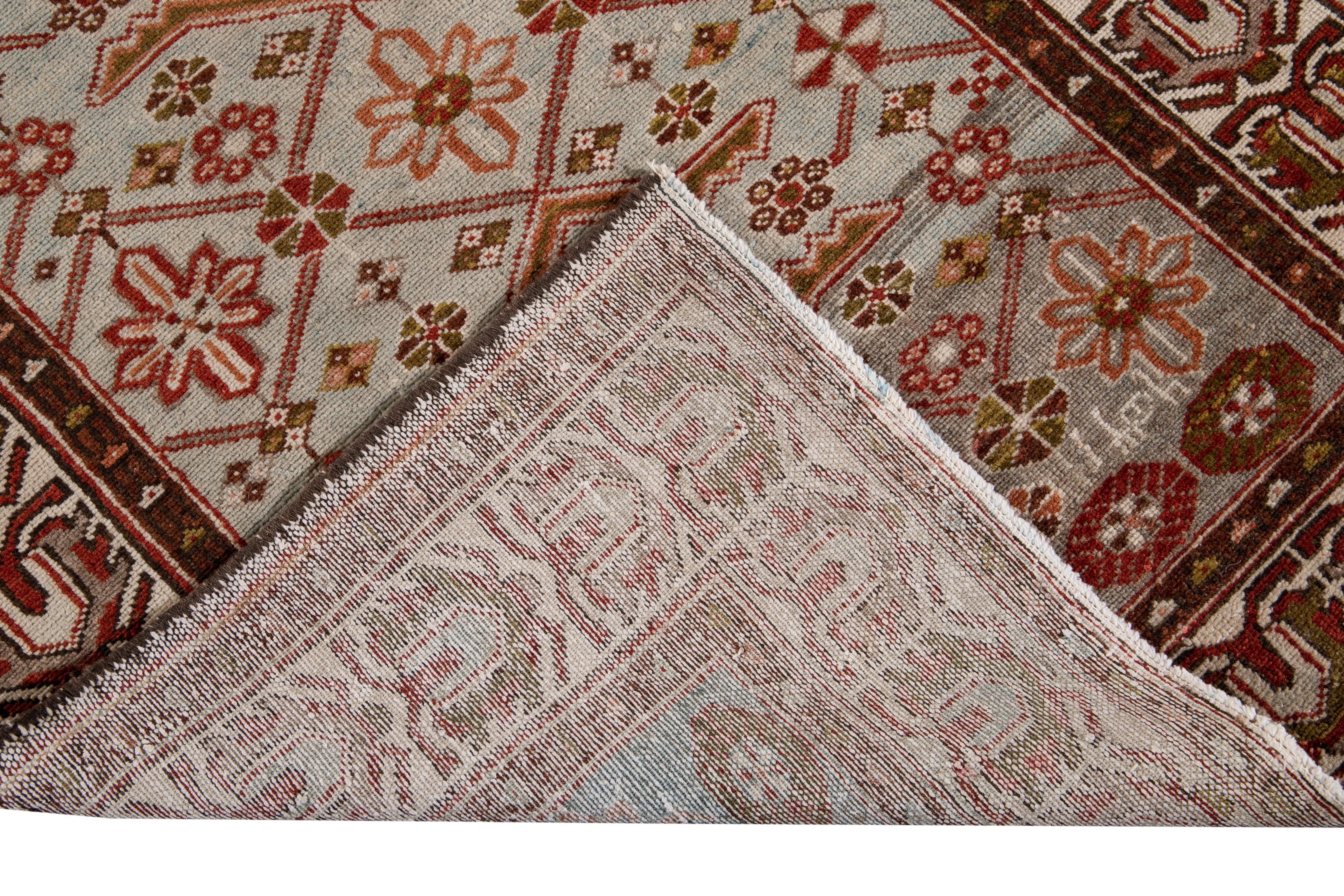 Beautiful antique Malayer hand-knotted wool rug with a grey field. This Malayer piece has brown, peach, and red accents in a gorgeous all-over floral design.

This rug measures: 3'5