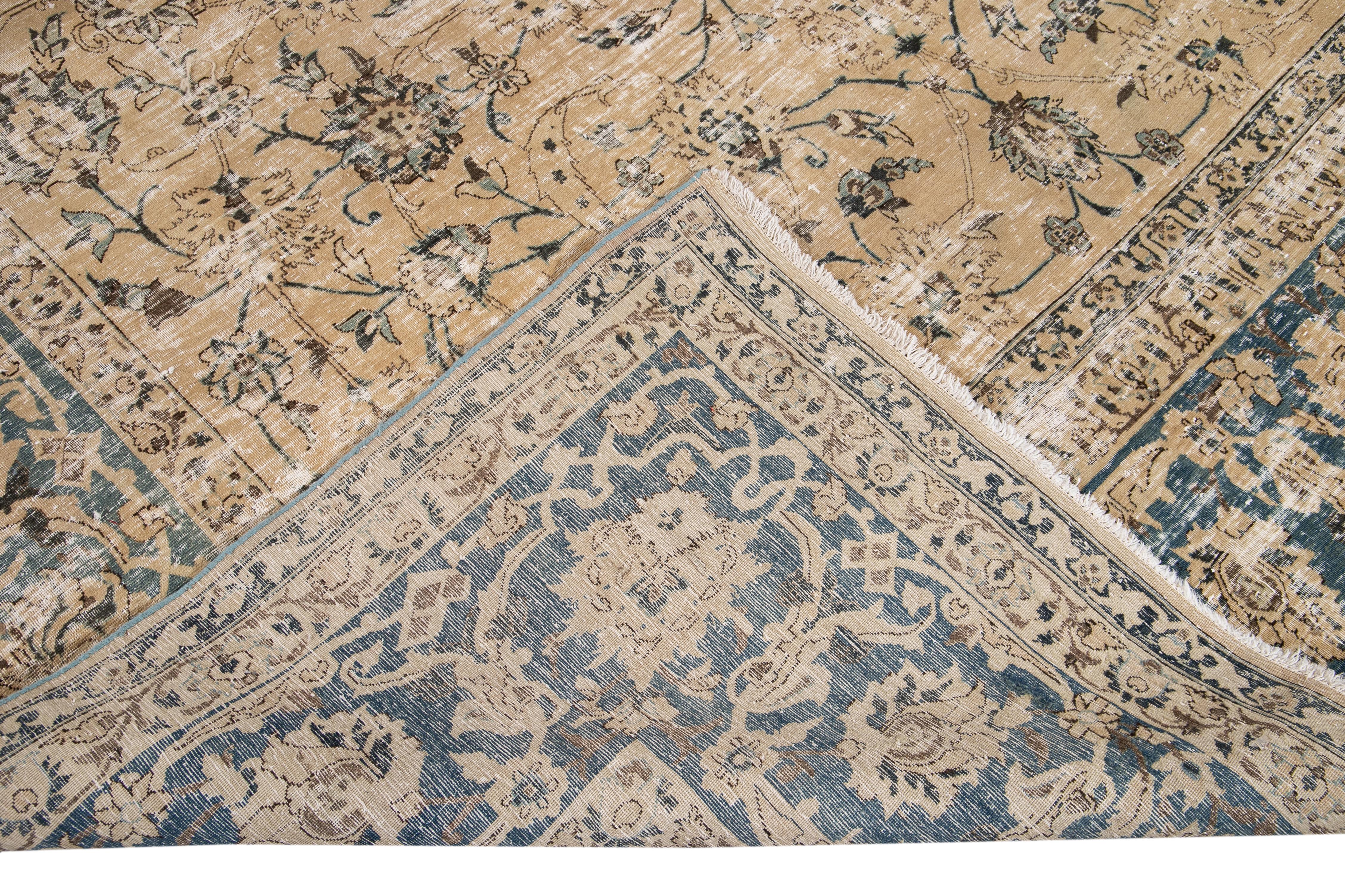 Beautiful antique Malayer hand-knotted wool rug with a beige field. This Malayer rug has a blue frame and accents of brown and blue in an all-over gorgeous medallion floral design.

This rug measures: 9'10