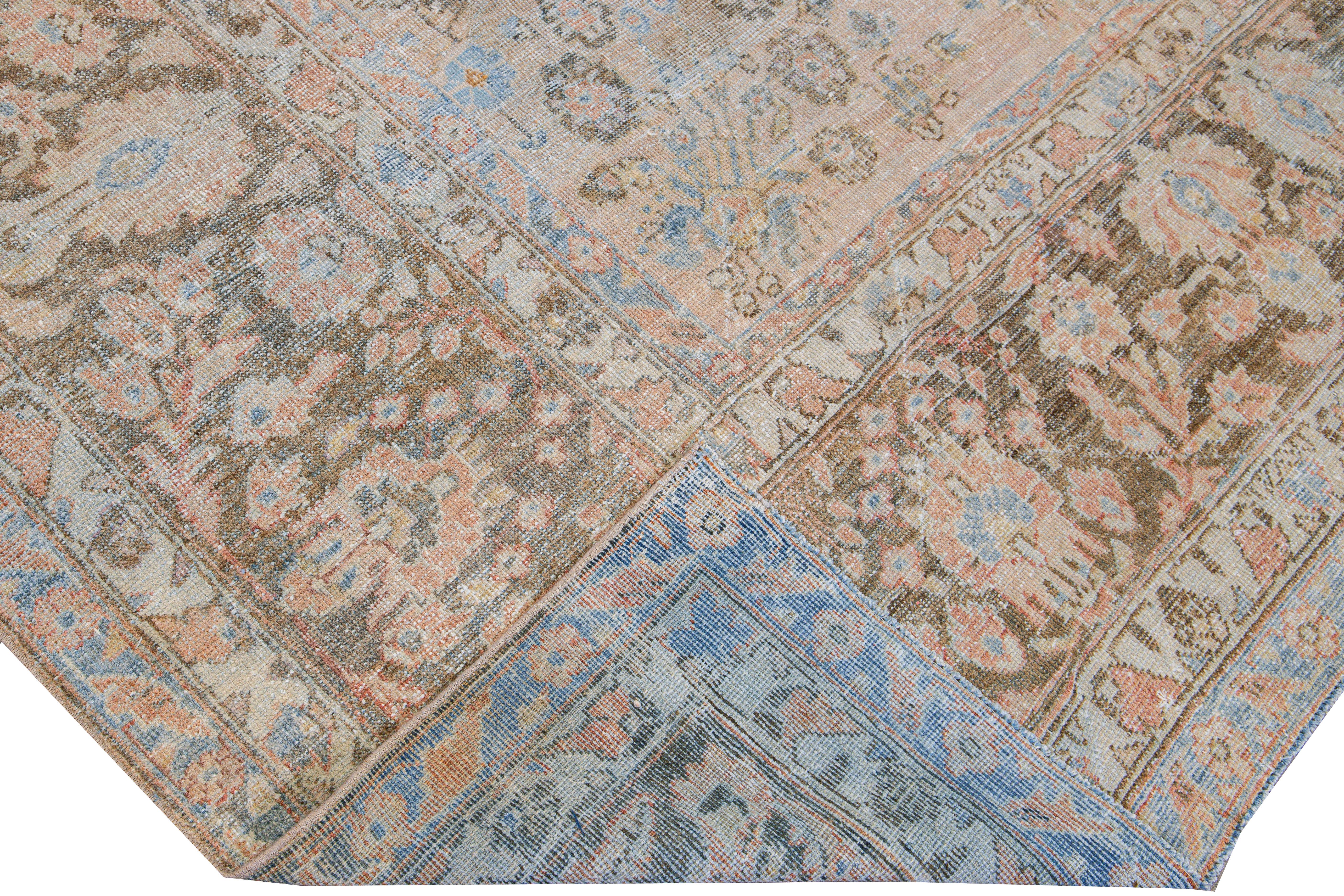 Beautiful antique Malayer hand-knotted wool rug with a blue and peach field. This Malayer piece has a brown frame and red accents in a gorgeous all-over floral pattern design.

This rug measures: 7'9