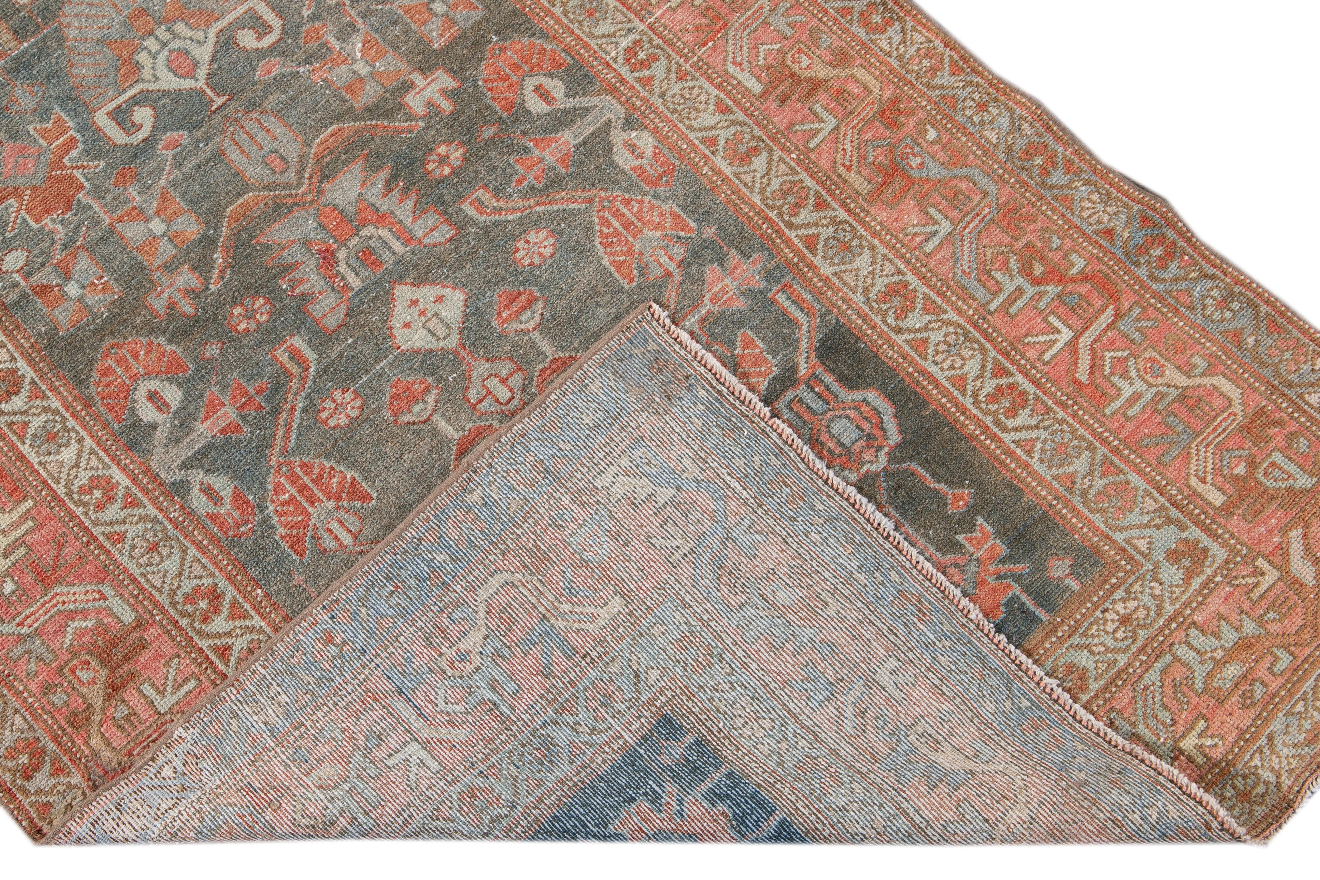 Beautiful antique Malayer hand-knotted wool rug with a navy-blue field. This Malayer rug has a peach and rusted frame and accents of beige and orange in an all-over gorgeous medallion floral design.

This rug measures: 3'6
